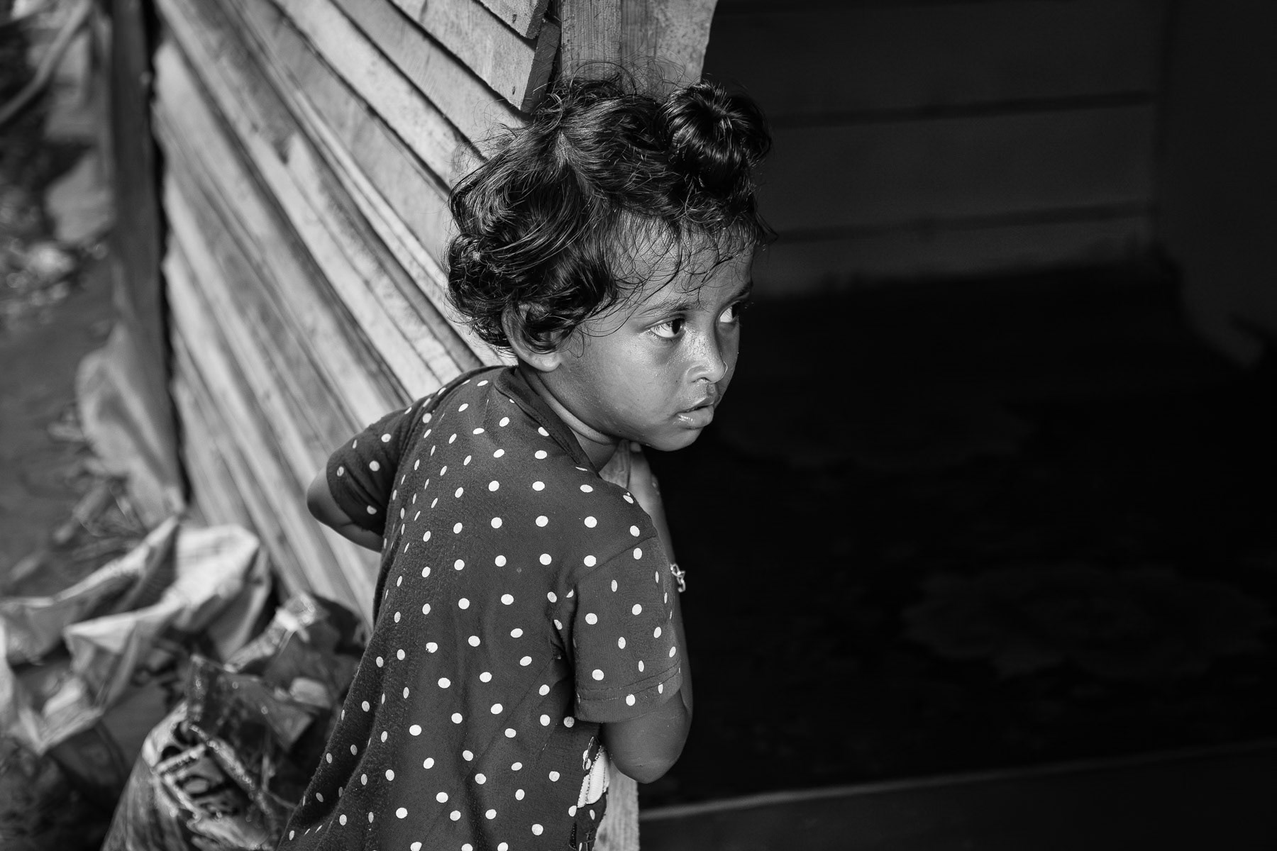 A young Rohingya girl endures the harsh realities of a squalid refugee camp in Sumatra, Indonesia, May 2025