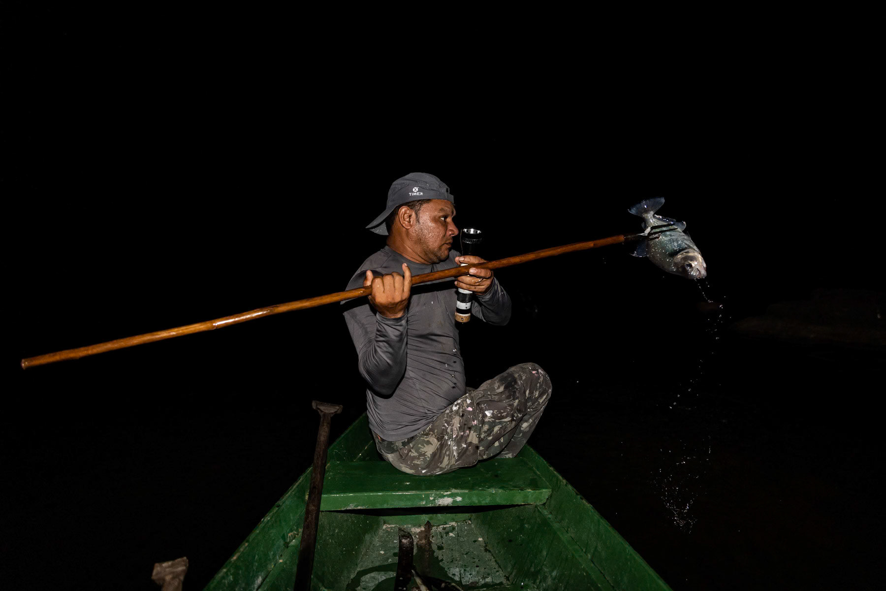 Spear fishing at night for piranha. Urubu river basin, Amazonas state, Brazil, November 2020