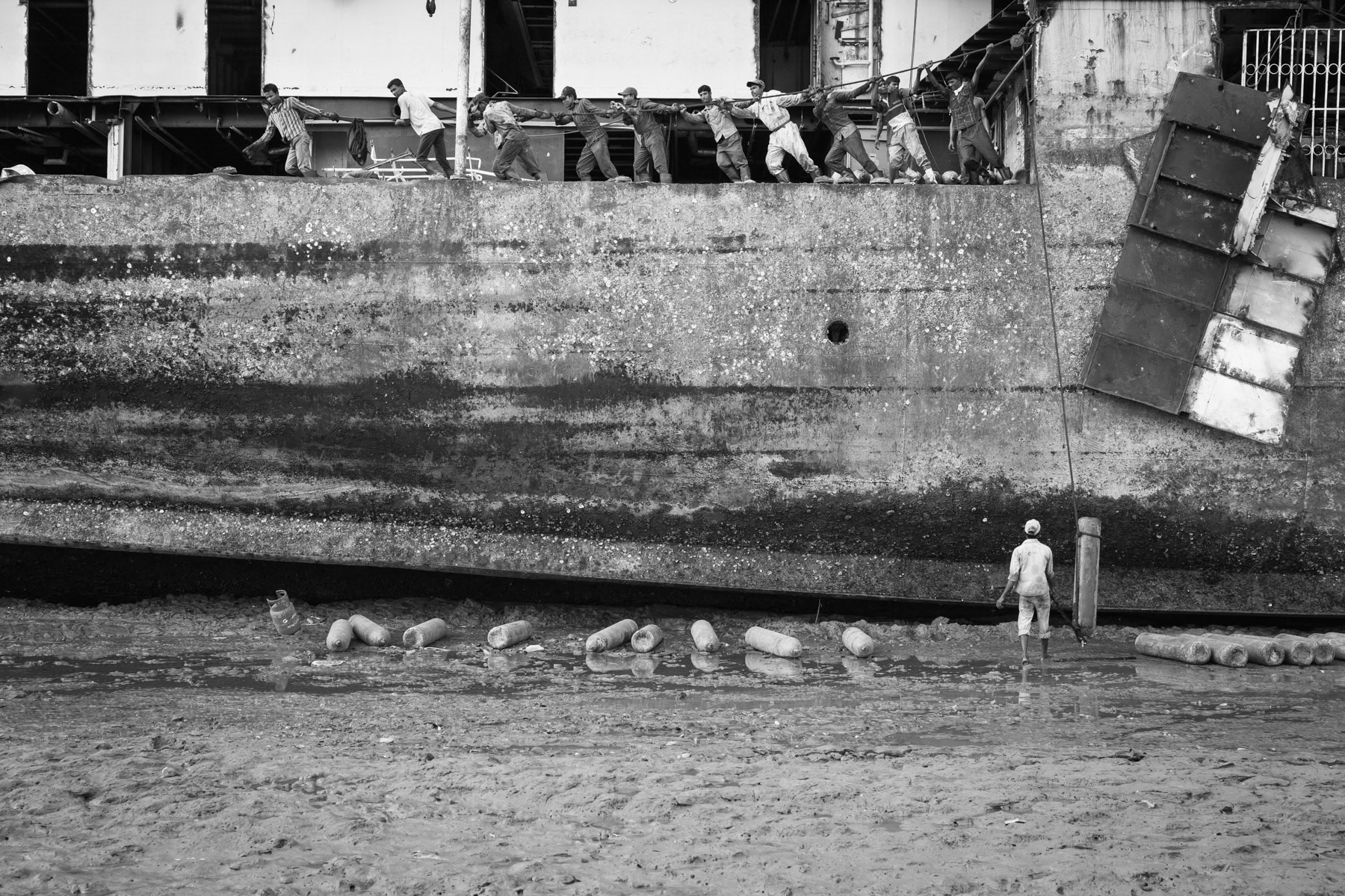 Workers lifting gaz tanks needed to cut the ship in pieces, Chittagong Ship-breaking yards, Bangladesh, June 2015