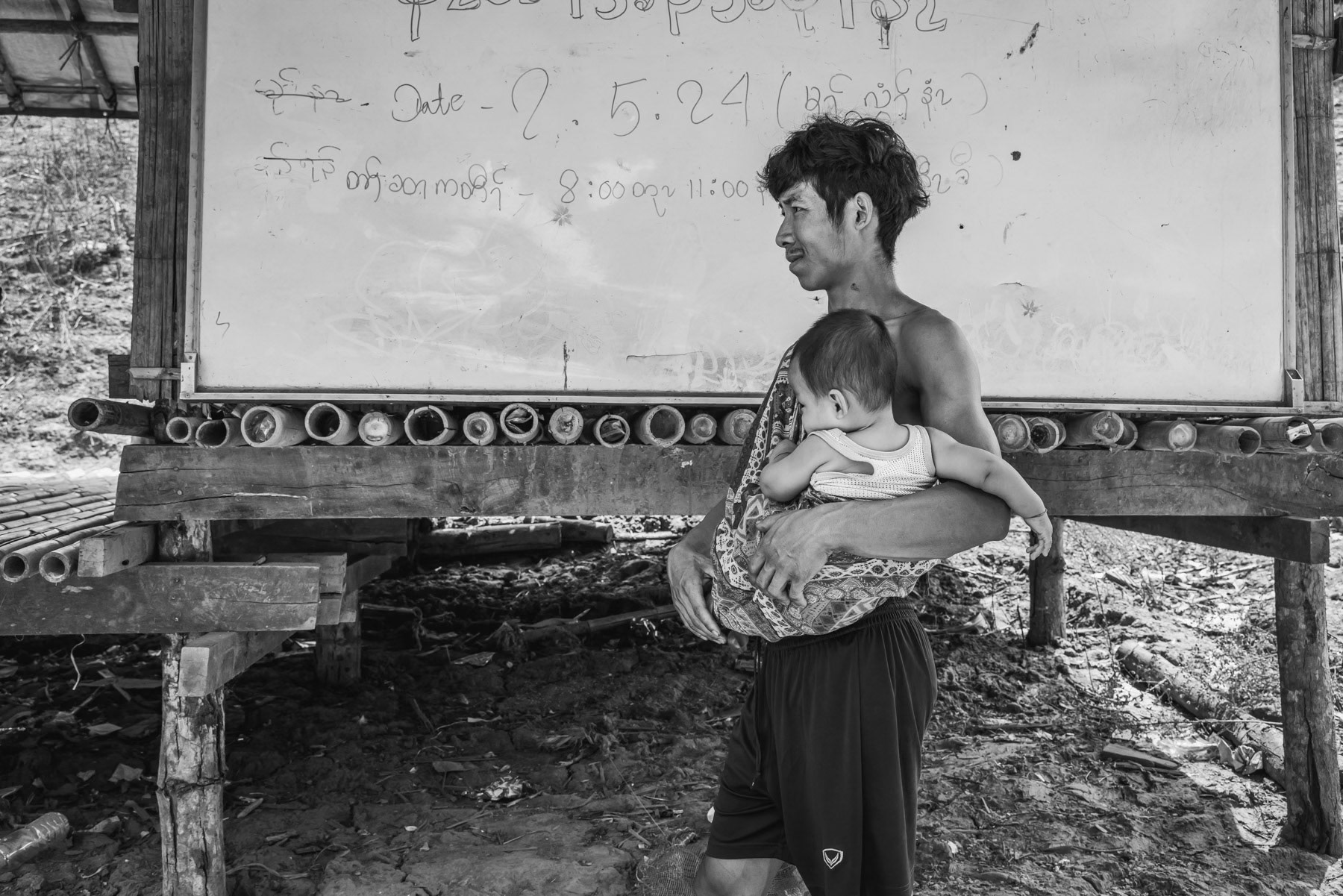 Father and his son from the Karen ethnic minority coming to the community center of a IDP camp in Karen State. Htaw IDP camp, Kanele, Myanmar, May 2024