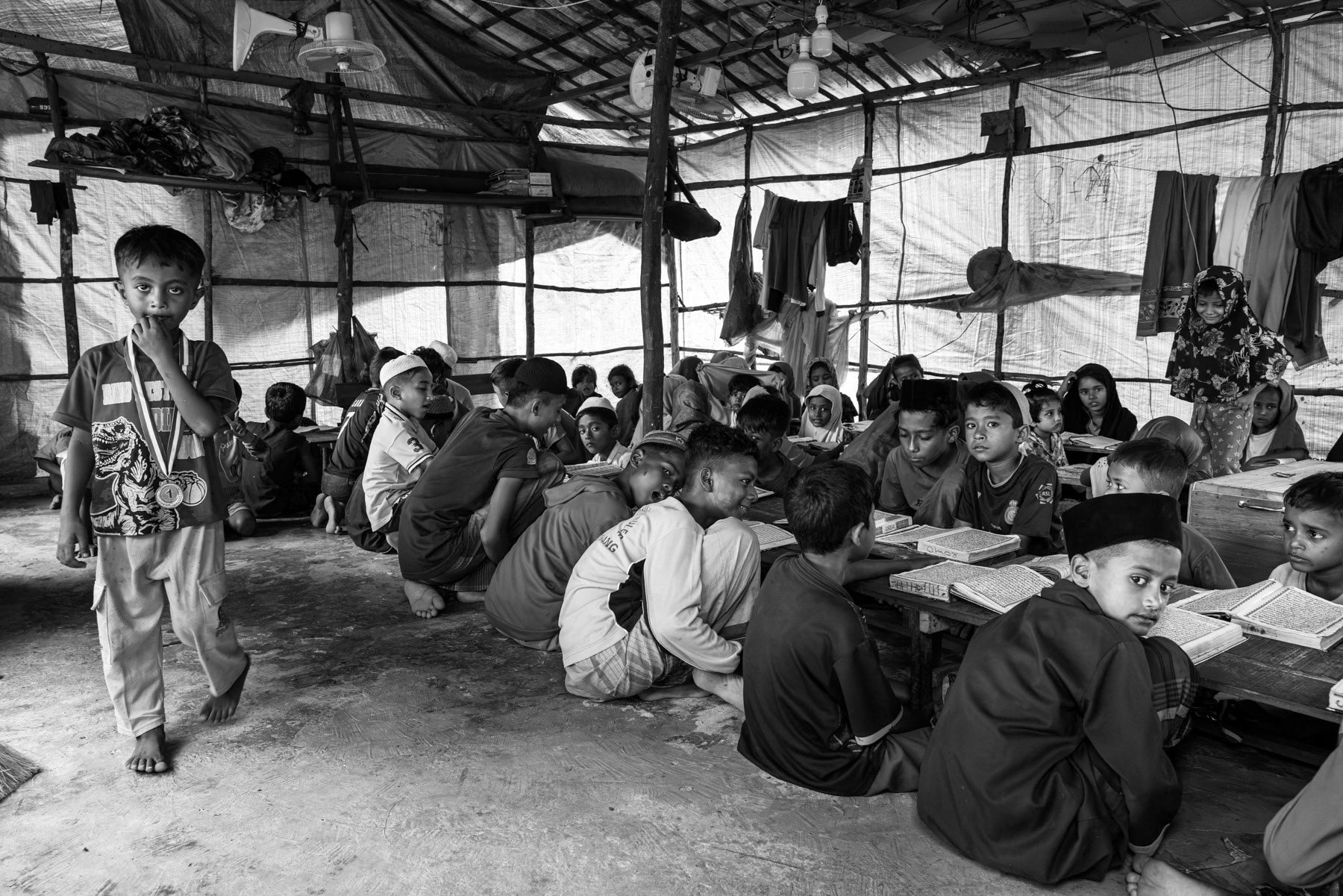 In a makeshift classroom set up by refugees, Rohingya children study the coran and other basic subjects. Rohingya refugee camp in Pekanbaru, Indonesia, October 2025