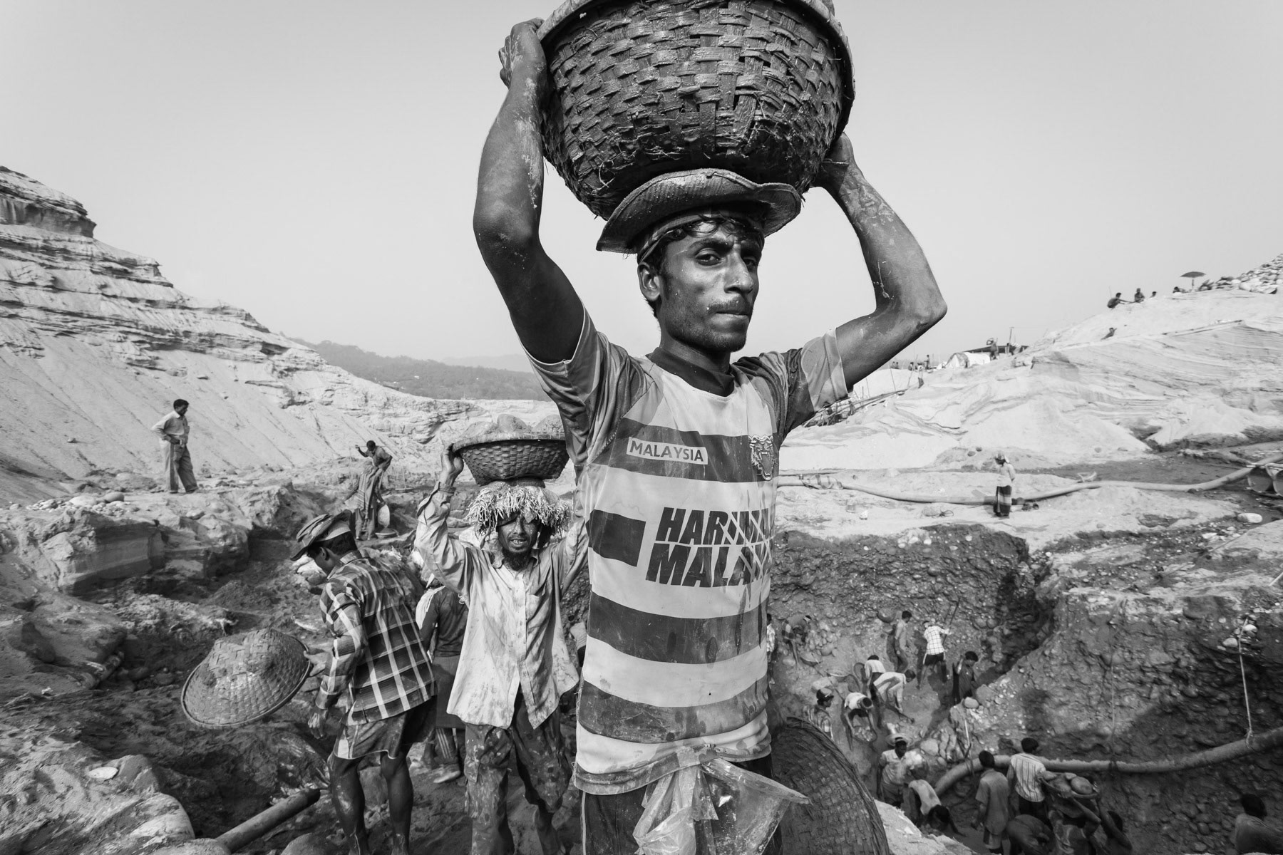 Carrying heavy loads of extracted stones, Jaflong, Bangladesh, December 2015