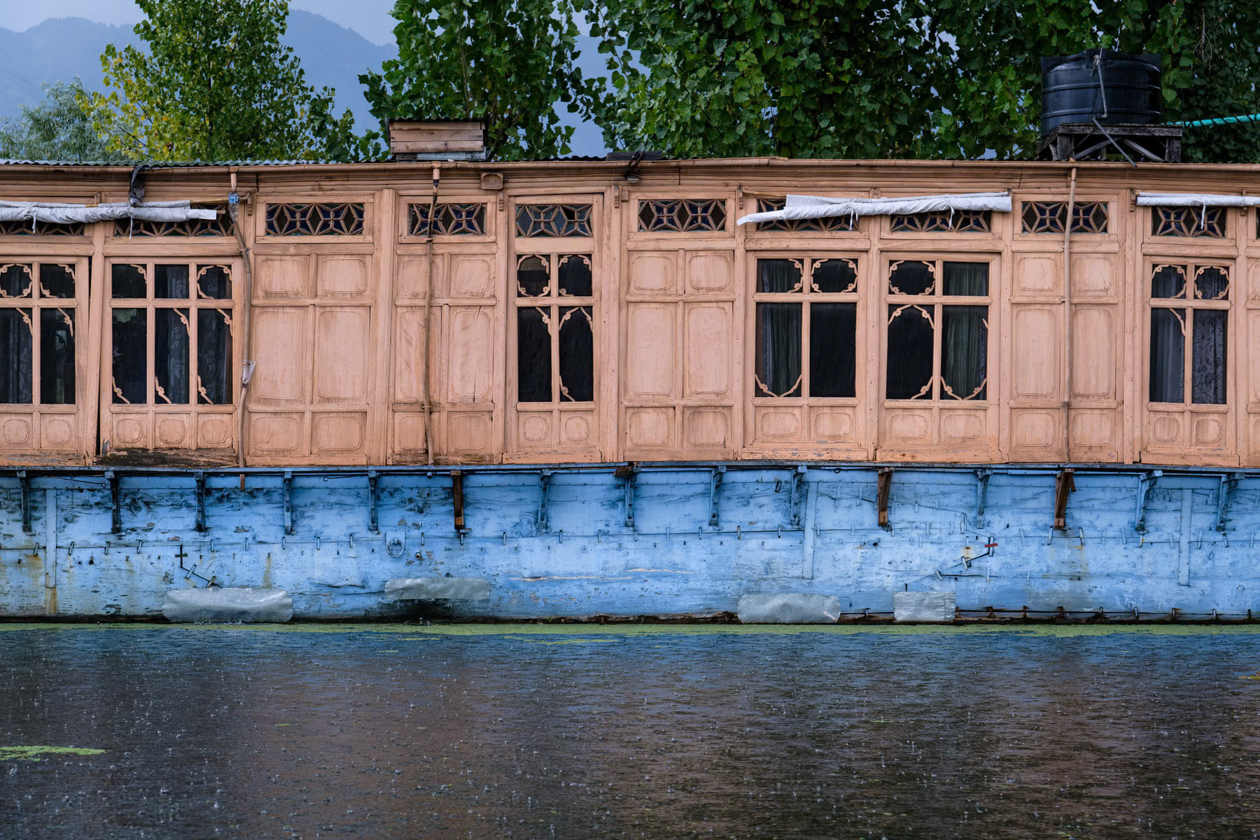 Traditional wooden boat house on Dal Lake, Srinager, Indian Administrated Kashmir, September 2023
