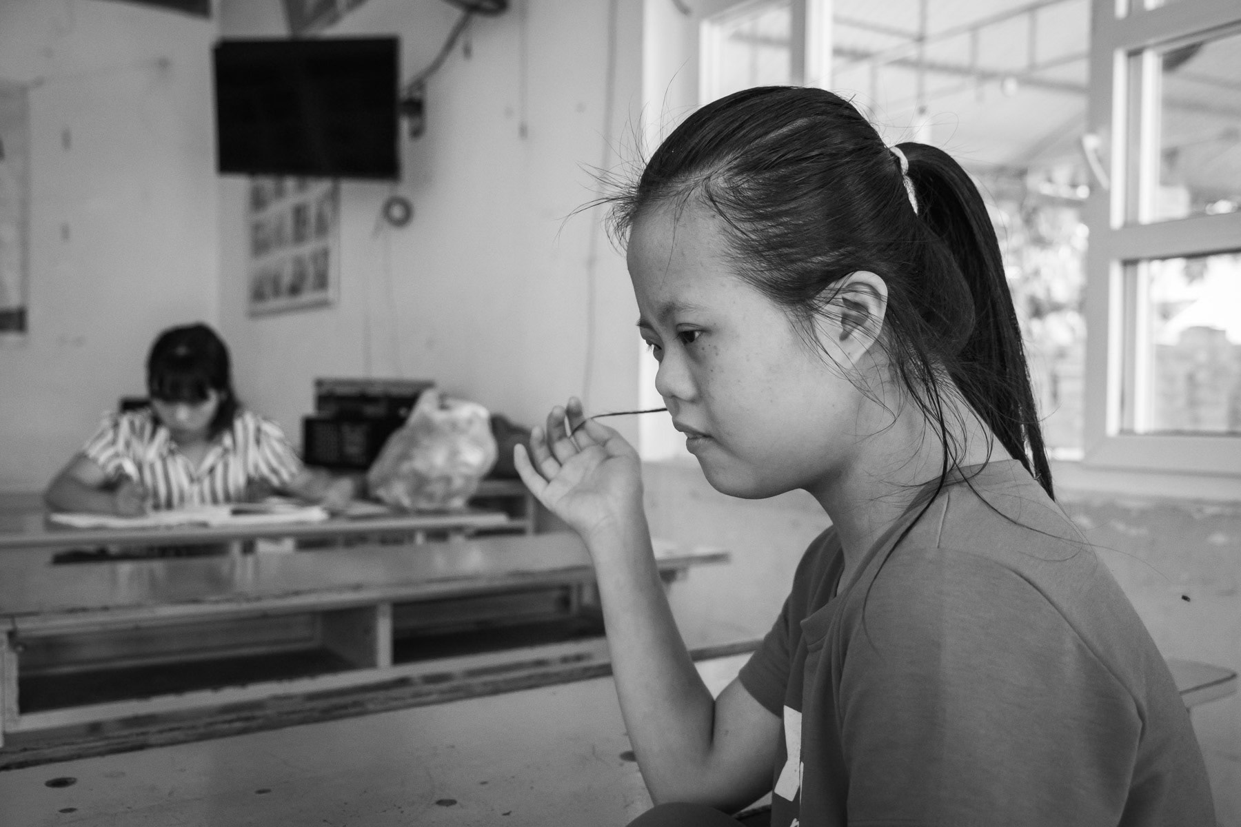 Agent Orange victim in a day care centre managed by the Vietnamese Association for Agent Orange Victims (VAVA). Agent Orange is a chemical defoilant rich in dioxin that was massively used by the American Army in clearance operations during the Vietnam War. Although its use was stopped in 1971, almost 50 years later desendants of affected victims are still born with mental and/or physical problems due to the toxicity of the dioxin passed on through generations. Da Nang, Vietnam, April 2018