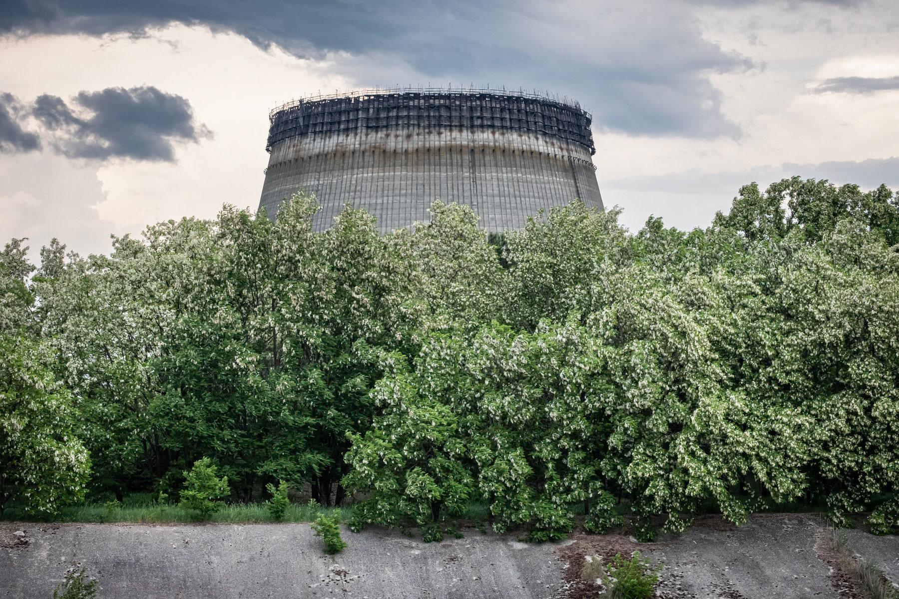 Cooling tower of nuclear power plant 5 which was nearly finished and supposed to be put in function in October 1986. After the explosion of reactor 4, all expansion works were stopped indefinitely. Plans existed to expand the Chernobyl nuclear power plant (NPP) to ten reactors by the year 2000 which would have made it the largest in the world. The accident of 26 April 1986 and later the collapse of the Soviet Union put a definite halt to it. Chernobyl NPP, Ukraine, June 2021