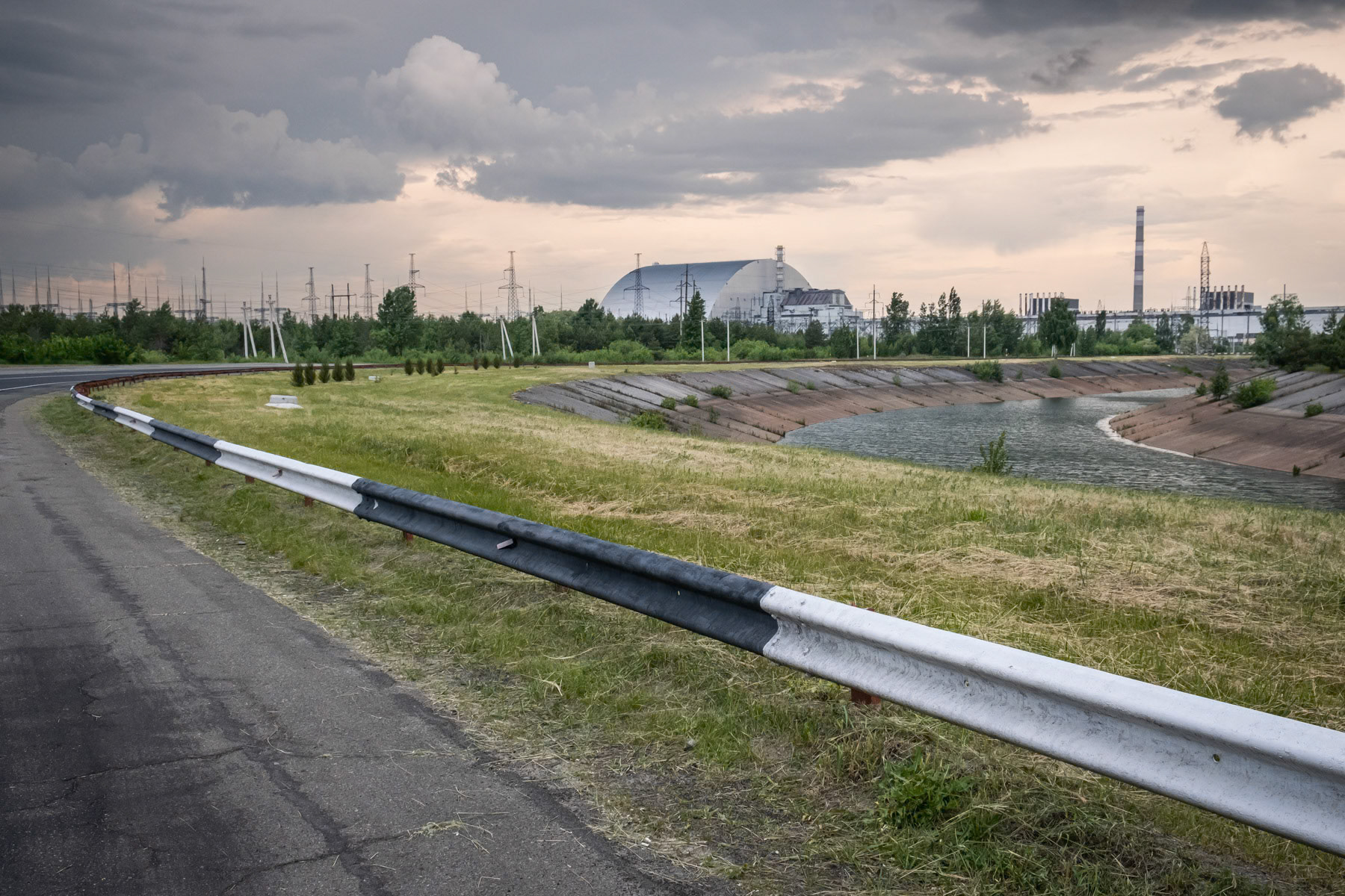 Reactor number 4 protected by a new dome finished in 2016, thirty years after the nuclear catastrophe of April 1986. The new dome protects the original concrete shelter that was build in the aftermath of the catastrophe despite high radiation levels. The original shelter was completed by 30 November 1986 at an extreme high human cost. Chernobyl NPP, Ukraine, June 2021