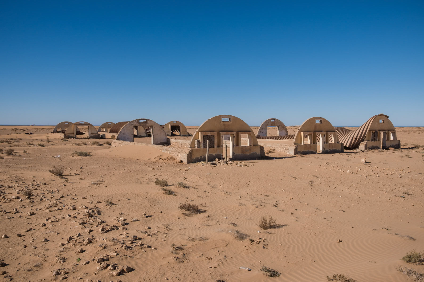 The Western Sahara, a former Spanish colony in Northwestern Africa is a territory where the has been living in limbo for more than forty years in one of Africa's longest frozen conflict. A tiny part of desert in the East bordering Algeria is controlled by the Polisario, a Sahrawi nationalist independence movement and is separated by a heavily mined 1,600 kilometre sand wall which divides the Western Sahara in two. Morocco is in full control of the coastal lands West of the sand wall and have all but fully integrated the resource-rich territory within Morocco. Over the years numerous people from Morocco have been moved to the Southern Provinces as they are officially called in order to consolidate their hold on the territory and to exploit its mining and fishstock resources. Old Spanish barracks near Laayoune. The Western Sahara was a Spanish colony until 1975. Laayoune region, December 2018