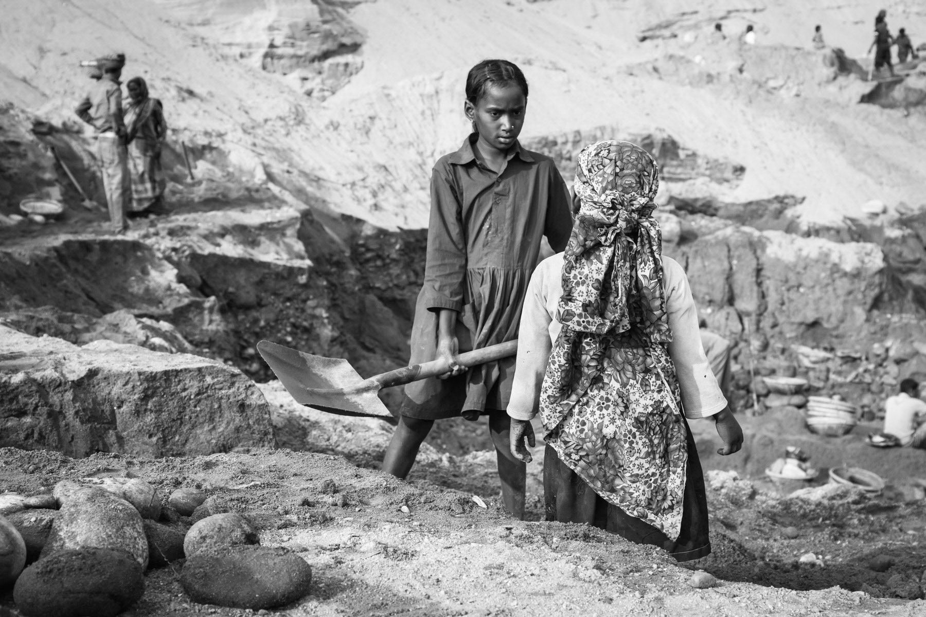 Child collecting stones in Goyain river bed, Jaflong in Bangladesh, December 2015