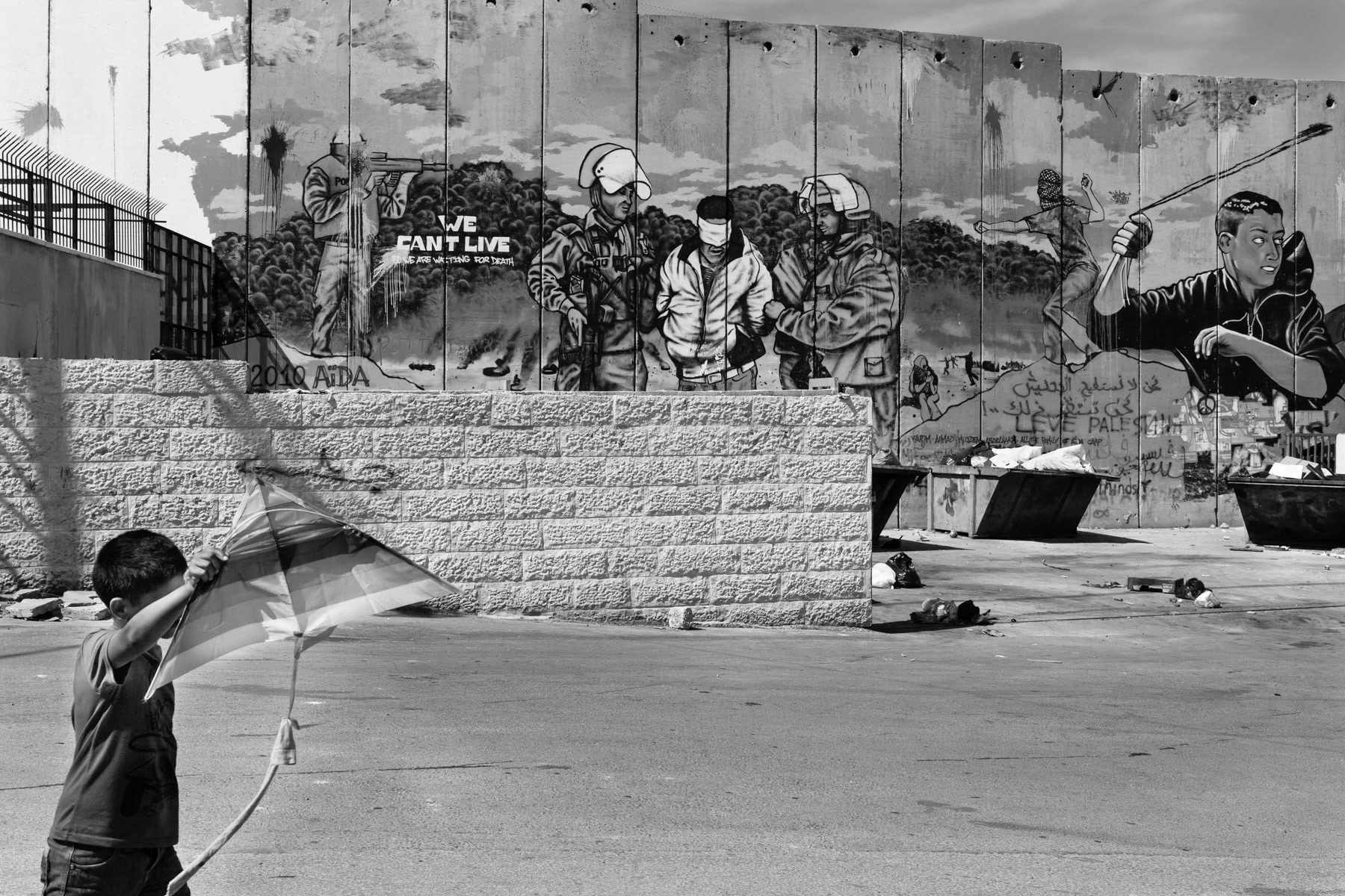 Boy along the separation wall in Aida Refugee Camp, Bethlehem, Palestinian Territories, May 2014