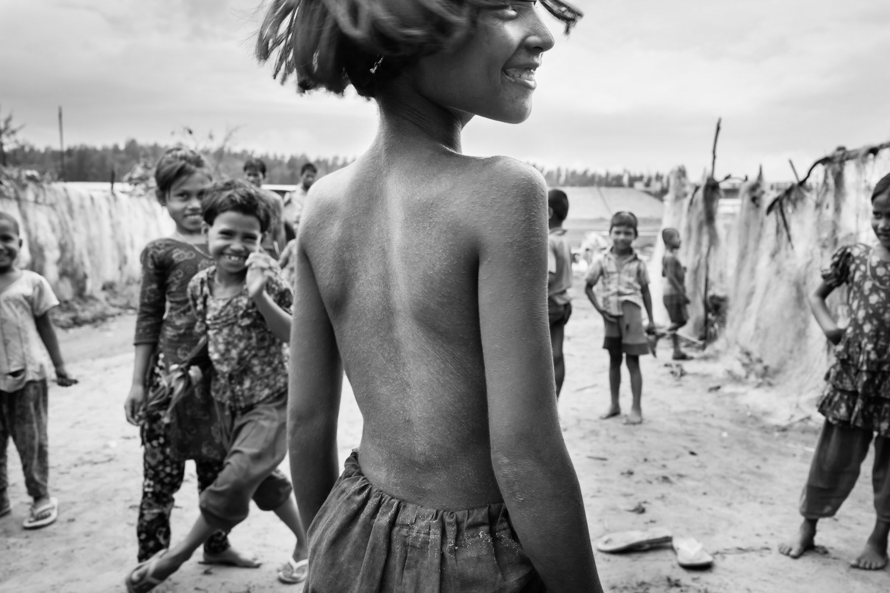 Children playing at a makeshift refugee camp for un-registered Rohingya refugees from Myanmar. Before the renewed waves of ethnic cleansing of 2016 and 2017 more than 250,000 Rohingya refugees were already living in Bangladesh. Shamplapur, Bangladesh, June 2015