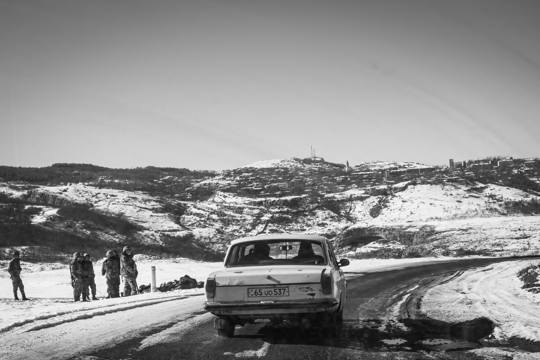 Armenian soldiers changing shift at their military positions with Shushi town in the background. A new reality for the Armenian population since most of southern Karabakh and the town of Shushi were captured by Azerbaijan during the 44-day war. Along the Karmir Shuka - Shushi road. Nagorno-Karabakh, January 2021