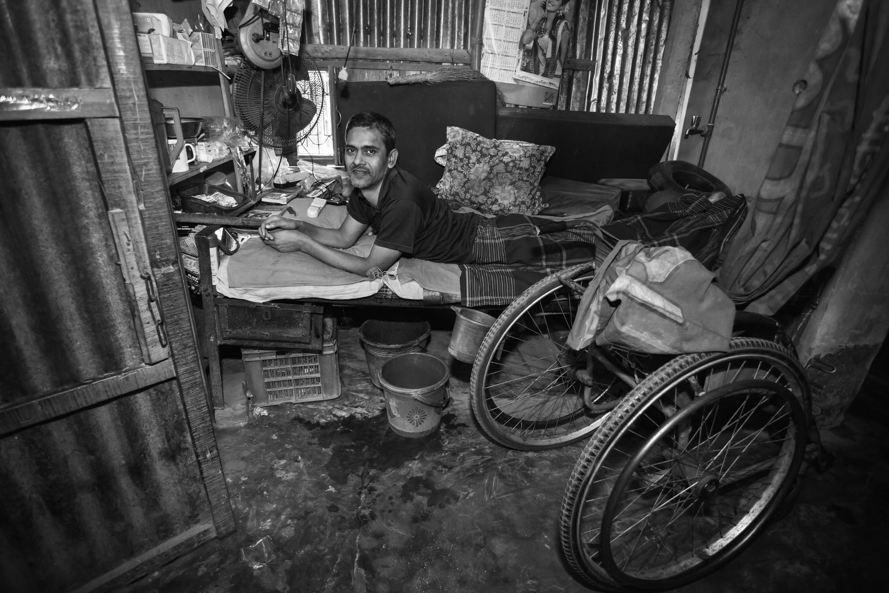 Home visit to a spinal cord injury patient managing a grocery shop donated by CRP, Hindukandi village near Bogra, Bangladesh, October 2014