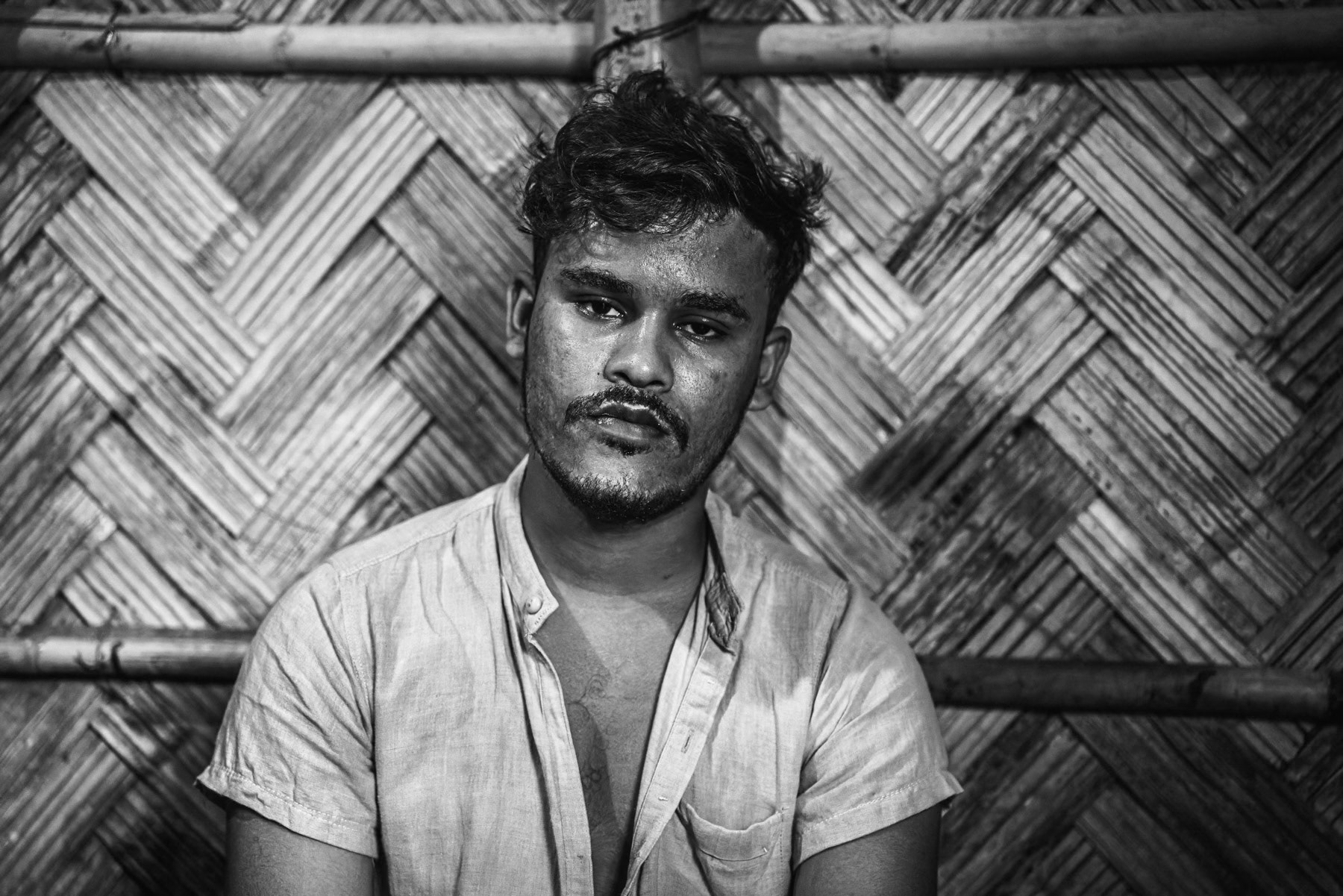 Aziz Khan, from Shida Fara village in Maungdaw, survived a drone attack near the Naf River while fleeing Myanmar on 25 August 2024. His parents, two brothers, and one sister were killed during the attack, and he sustained a leg injury. He left with his remaining family and arrived in Bangladesh on 27 August 2024. Before displacement, he worked as a shopkeeper in Maungdaw. Kutupalong refugee camp, Ukhiya, Bangladesh, September 2025