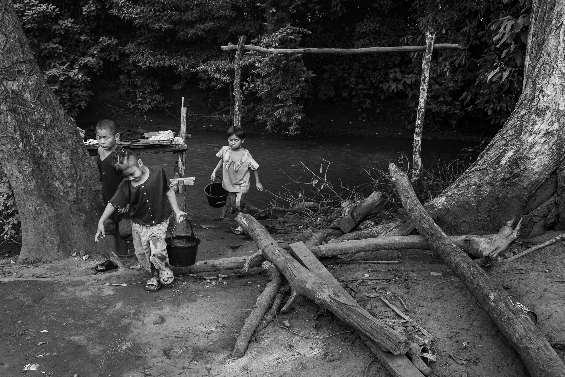 Children fetching water in the river, Karen State, Myanmar, May 2025