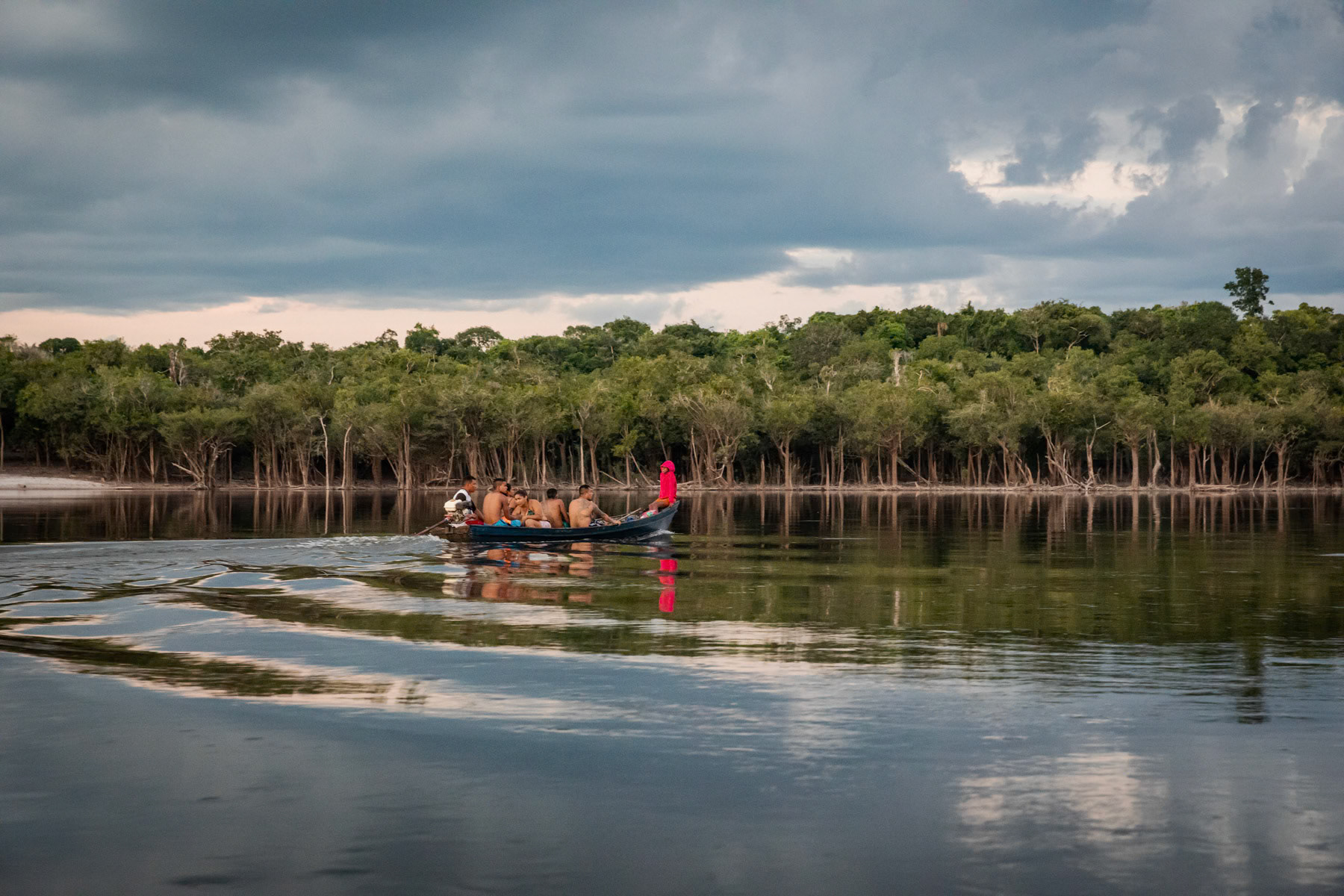 Villagers going to Lindoia, the first small town 2 hours away and closest for markets, basic healthcare and school. Children leave as early as 4am to reach school in time in the morning. Urubu river, Amazonia, Brazil, November 2020