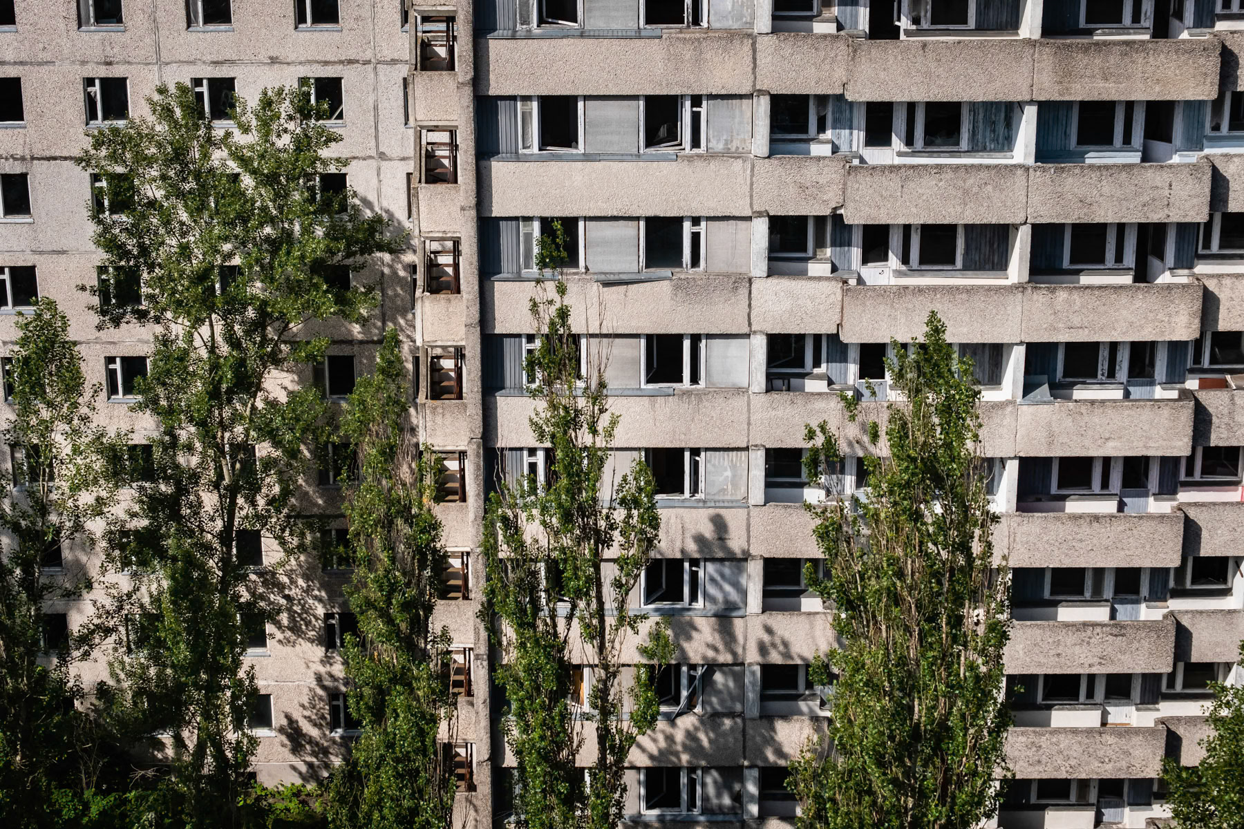 Pripyat town was developed alongside the nuclear power plant to house staff and their families. Before the disaster it consisted of 5 districts, each of them with well-developed infrastructure. There were 5 schools, 14 kindergartens, a cinema, swimming pools, theatre, shopping centres and residential buildings for 30,000 people with extensions planned of at least one more district near the port area. The complete population of Pipyat was evacuated 36 hours after the disaster to never return again. Pripyat is now an overgrown ghost town where time stood still on 27 April 1986. Pripyat, Chernobyl NPP, Ukraine, June 2021