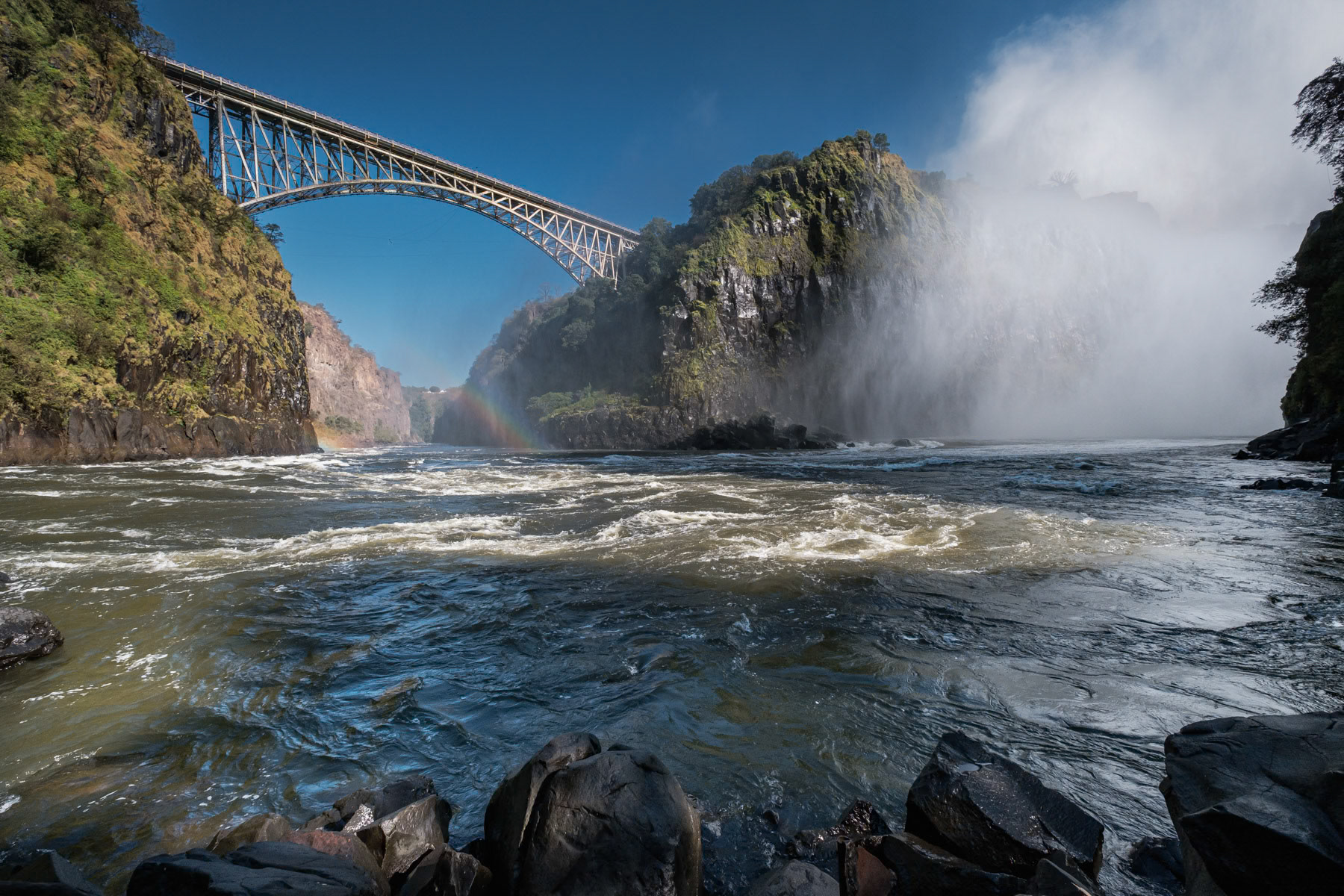 Boiling point of the Victoria Falls with the bridge linking Zambia and Zimbambwe. Livingstone, Zambia, June 2021