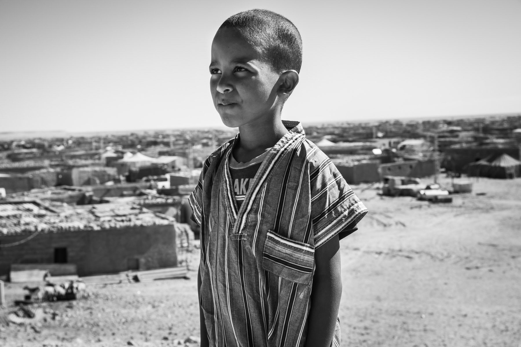 Saharawi child in Smara. Saharawi refugee camps were established in the seventies in an area managed by the POLISARIO, the government in exile of the Saharawi Arab Democratic Republic (SADR). Between 120 and 150,000 refugees from the Western Sahara live in 5 refugee camps in the desert south of Tindouf. Smara Refugee Camp, Algeria, December 2019