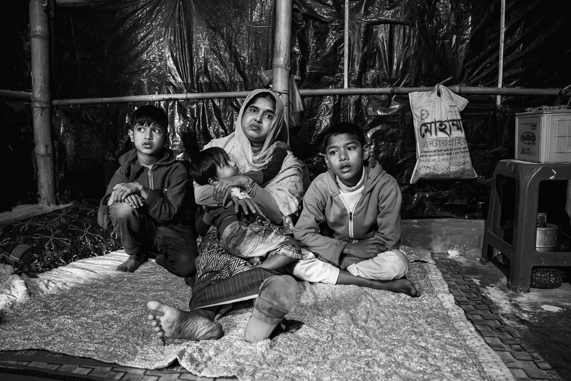 On August 2, 2024, Md Hares (45) and Setara (35) fled their home in Shidda Para, Rakhine, after an AA drone strike hit their house. The blast severely injured Setara, fracturing her femur. The tragedy deepened the following day when their 15-year-old son was arrested and tortured to death by the AA.Taking advantage of their village's proximity to the border, the couple immediately crossed into Bangladesh with their three surviving sons. Setara received initial treatment from MSF and was later referred to a hospital in Chittagong. Today, she remains dependent on crutches and external assistance to move. While she attends physiotherapy when possible, the family faces significant hurdles in accessing the specialized medical care she requires within the camp system. Leda Refugee Camp, Bangladesh, January 2026