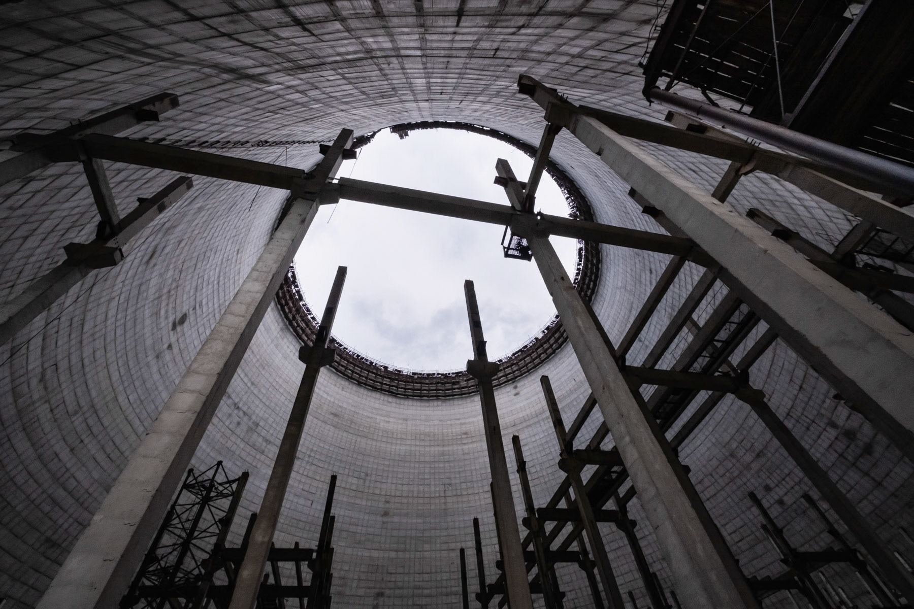 Unfinished cooling tower, from the inside, of nuclear power plant 5 and supposed to be put in function in October 1986. After the explosion of reactor 4, all expansion works were stopped indefinitely. Plans existed to expand the Chernobyl nuclear power plant (NPP) to ten reactors by the year 2000 which would have made it the largest in the world. The accident of 26 April 1986 and later the collapse of the Soviet Union put a definite halt to it. Chernobyl NPP, Ukraine, September 2021