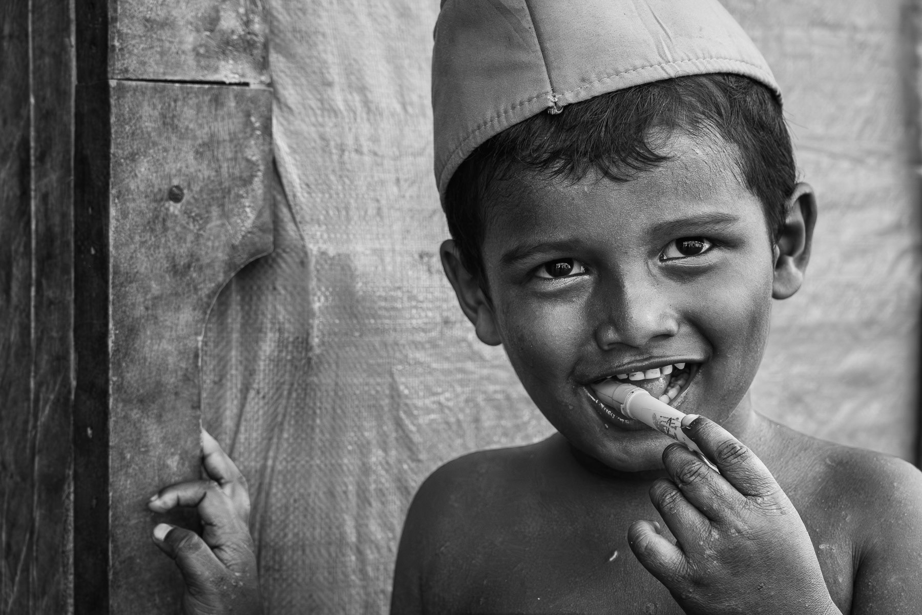 A young Rohingya child endures the harsh realities of a squalid refugee camp in Sumatra, Indonesia, May 2025