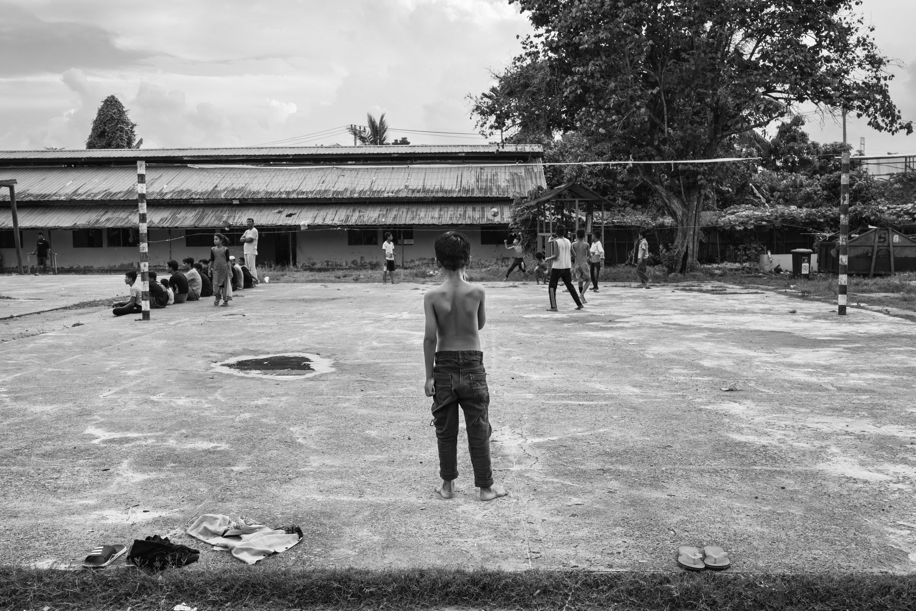 Rohingya children playing and now living in barracks where they are held since they arrived on the shores of Aceh after a sea crossing from Myanmar and Bangladesh. All had to pay high amounts to traffickers to make the perilous journey and escape persecuation. Padang Pijie, Sumatra, Indonesia, October 2023