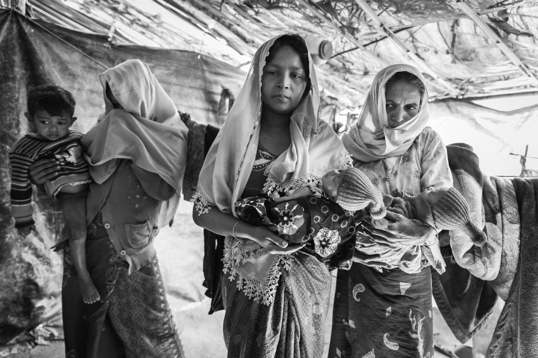 Rohingya women that fled ten days earlier from their village north of Maungdaw in Myanmar. One of the women gave birth to twins while escapting through the jungle. Their husbands have been killed during the military security operations that started in October 2016 in northern Rakhine near the border with Bangladesh. Human rights groups have classified the security sweeps as ethnic cleansing campaigns. Balukhali camp for newly arrived refugees, Bangladesh, February 2017