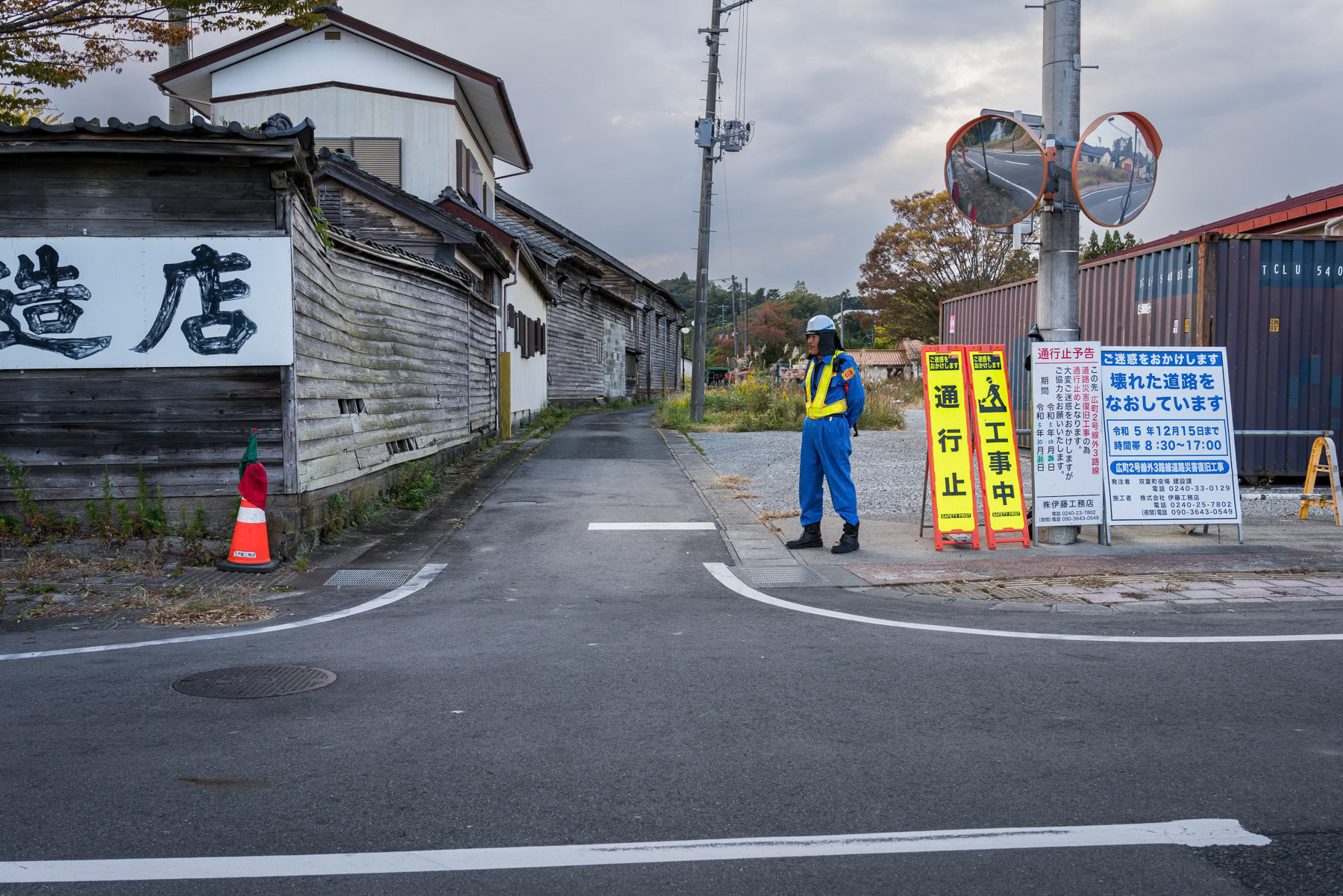 Worker monitoring access to a temporary working site in the off-limit and contaminated area around Fukushima nuclear power plant. Futoba, Fukushima, Japan, October 2023