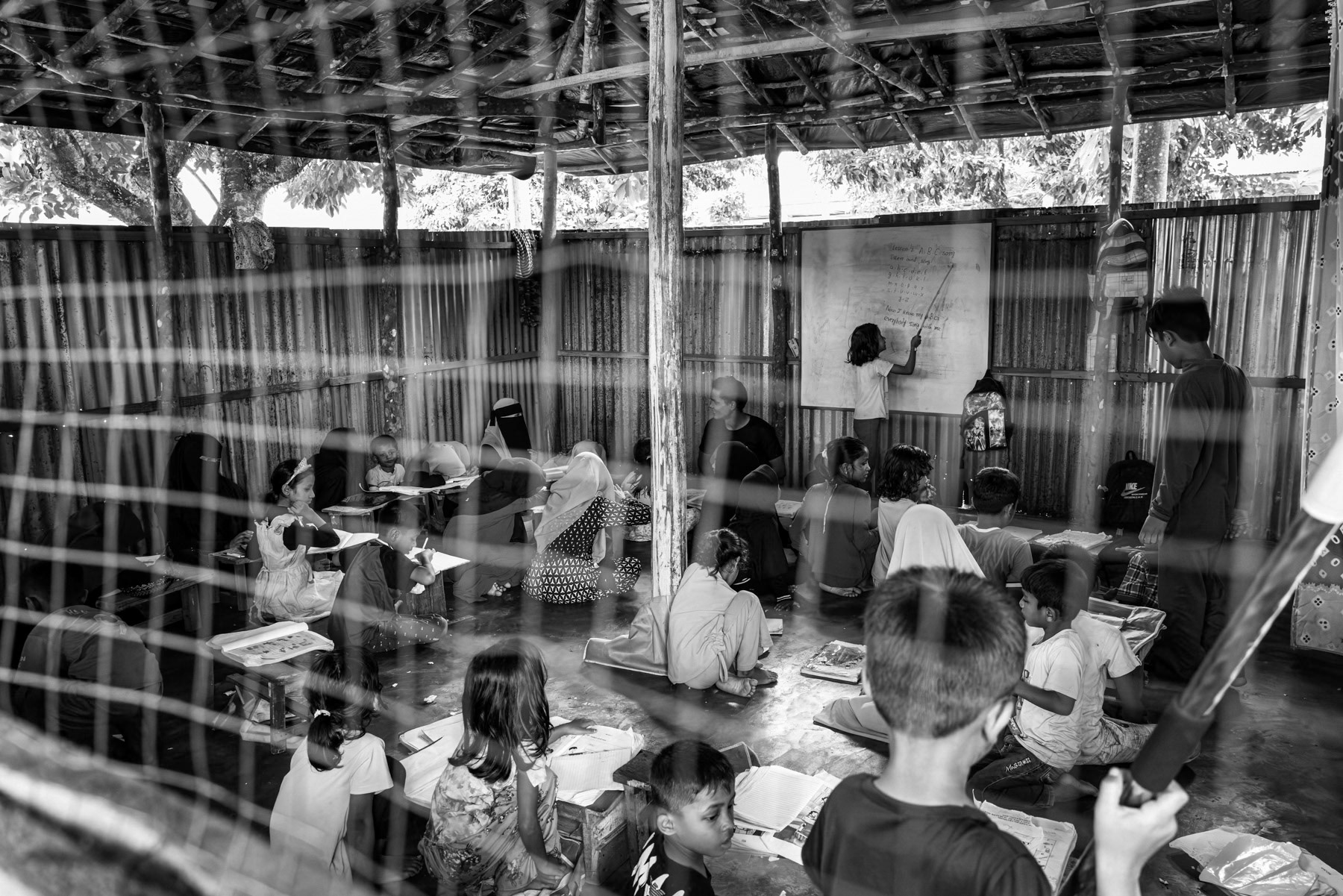 Rohingya children and young adults attends a community-run improvised classroom, where volunteers teach basic lessons to boys and girls who are barred from attending local schools. Pekanbaru, Indonesia, October 2025