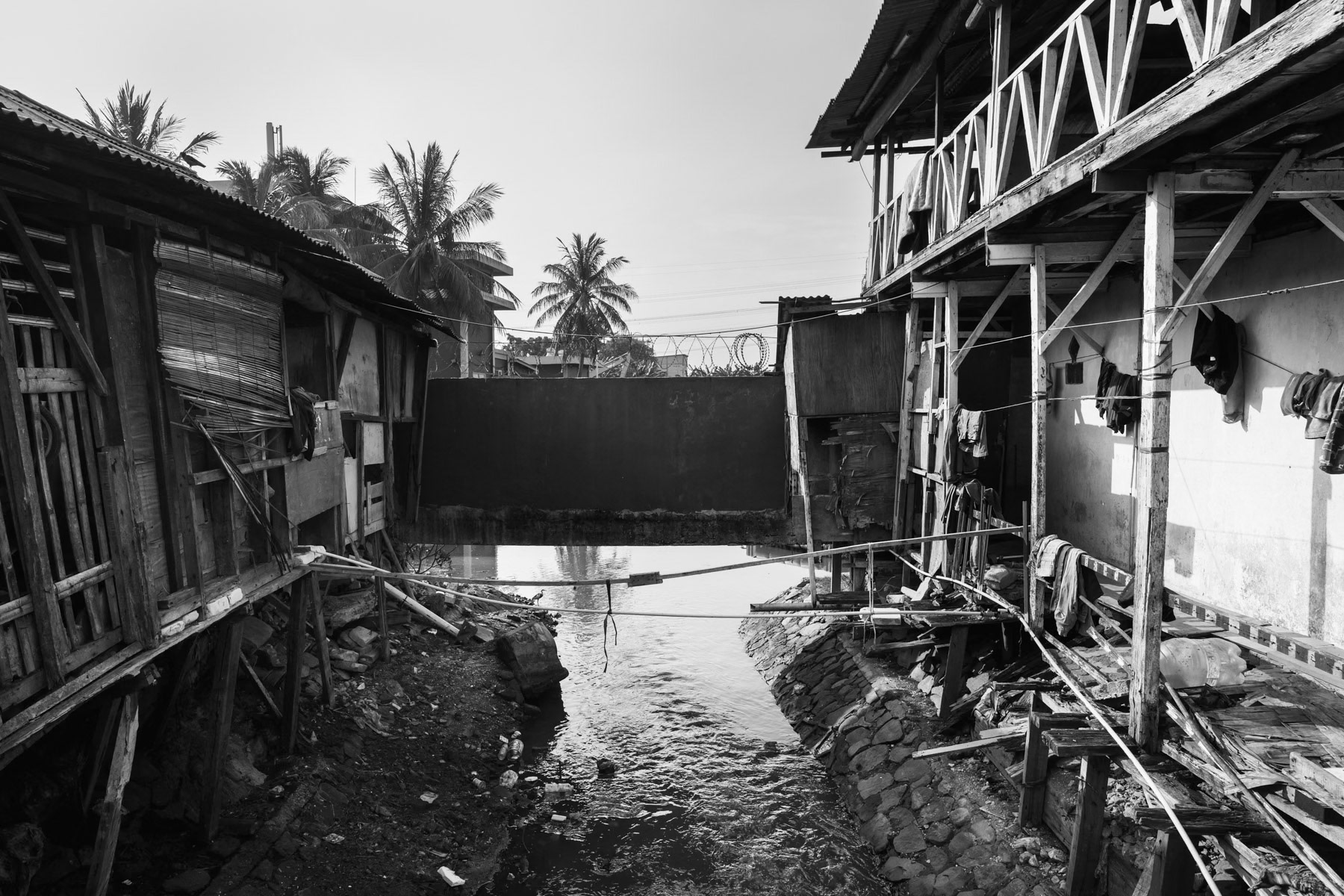 Land plot from where more and more people are being evicted . Land rights and land ownership is a big issue affecting mainly poor families from the fishing community. Soil sinking, rising sea levels and floods make their survival even more precarious. Muara Angke neighbourhood, North Jakarta, Indonesia, June 2022