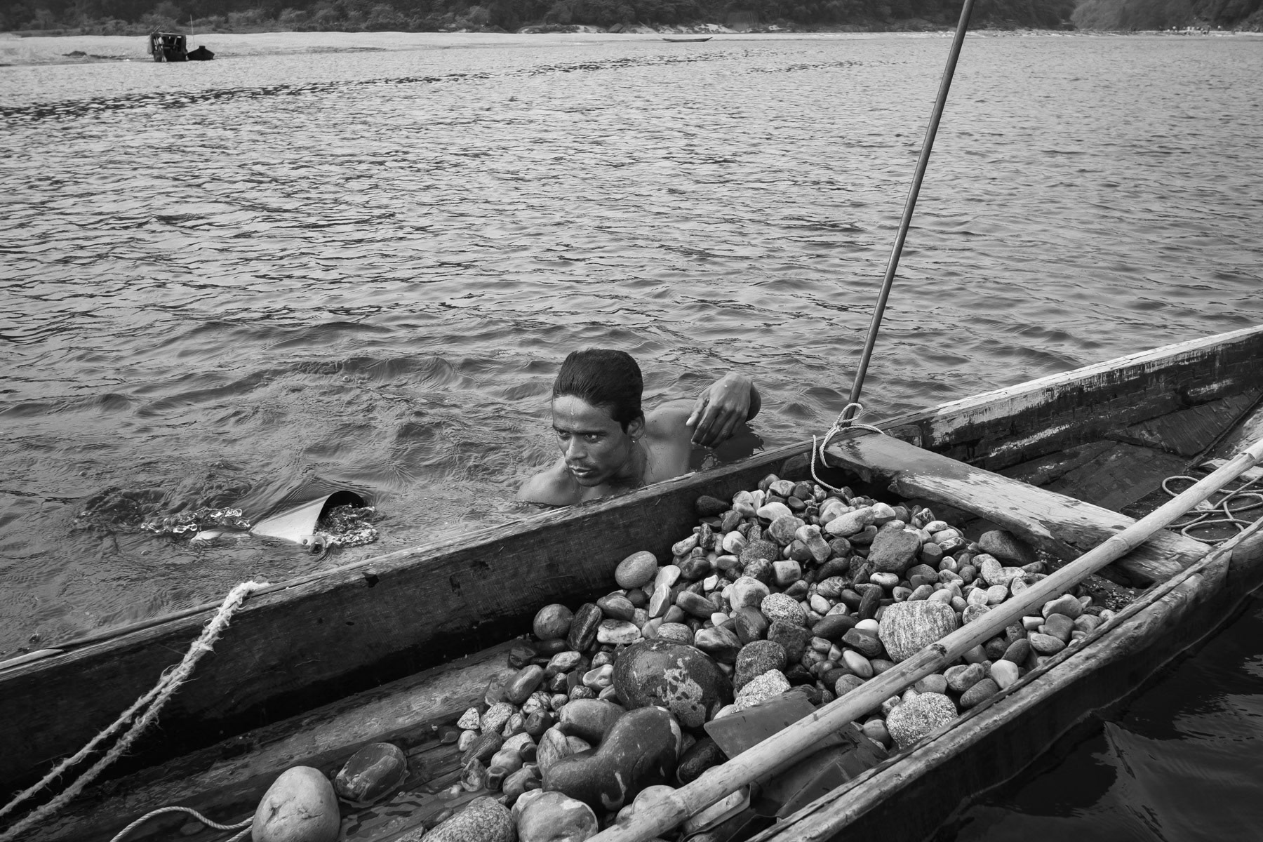 Diver fetching stones at a depth 4 to 8m in the Goyain river near Tamabil, Bangladesh, May 2016