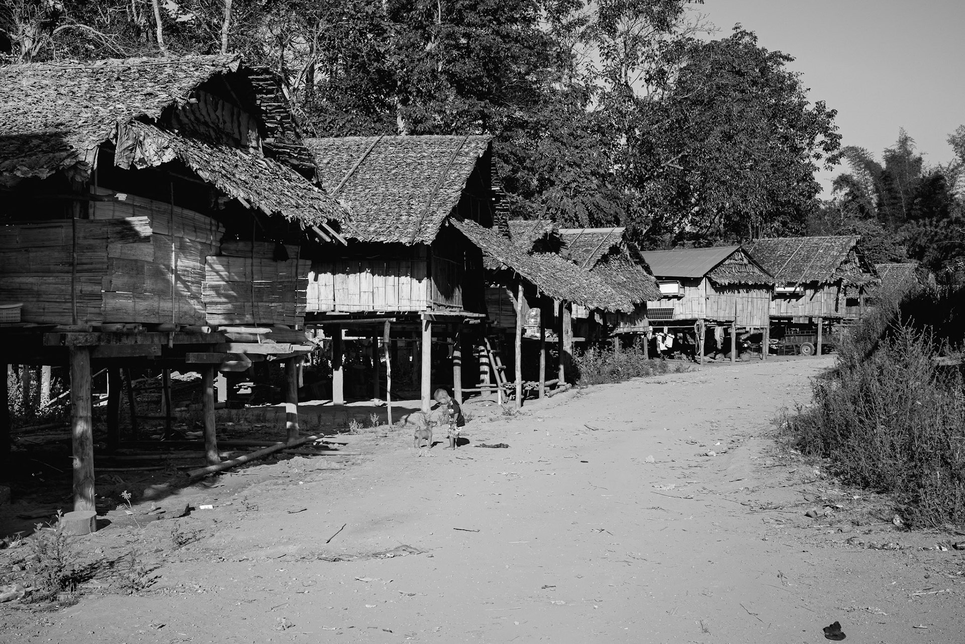 Rows of traditional elevated huts form the spine of the Kanele Htaw camp. These structures house families who have fled frontline violence, only to find themselves back in the crosshairs of aerial surveillance. Kayin State, Myanmar, January 2026