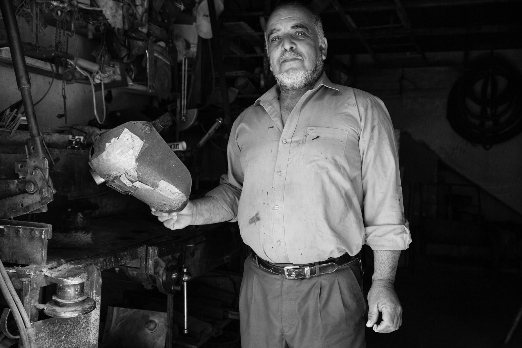 Man posing in his workshop, Balata Camp, West Bank, May 2014