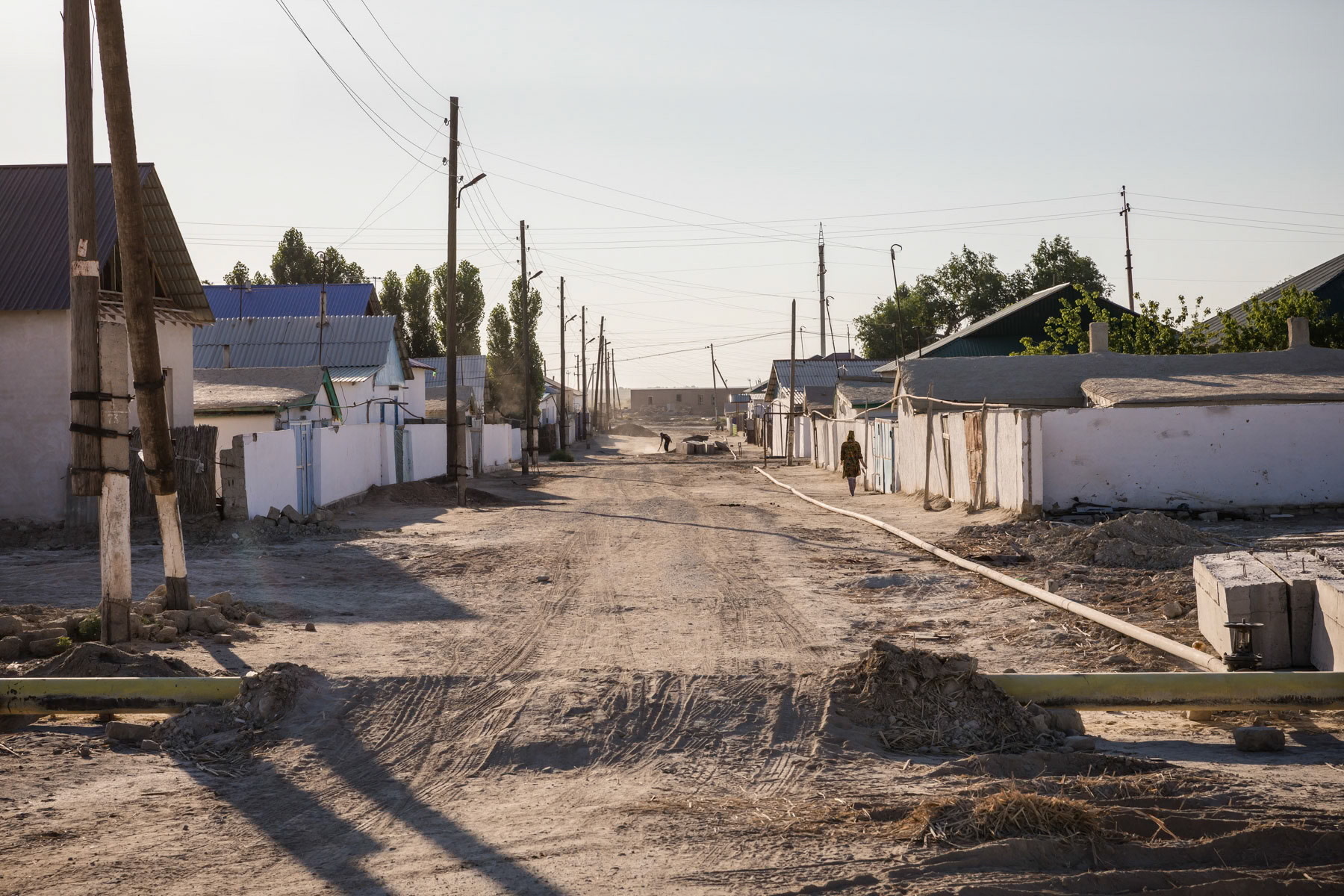 The port town of Muynak which used to be the main Aral Sea port in Uzbekistan with fish processing factories and large population. Muynak is now 150 Km or a 6 hours off-road drive to the shore of the Aral Sea. The town is now a semi abandonned dusty desert town far from cities and infrastructure. Muynak, Uzbekistan, June 2019