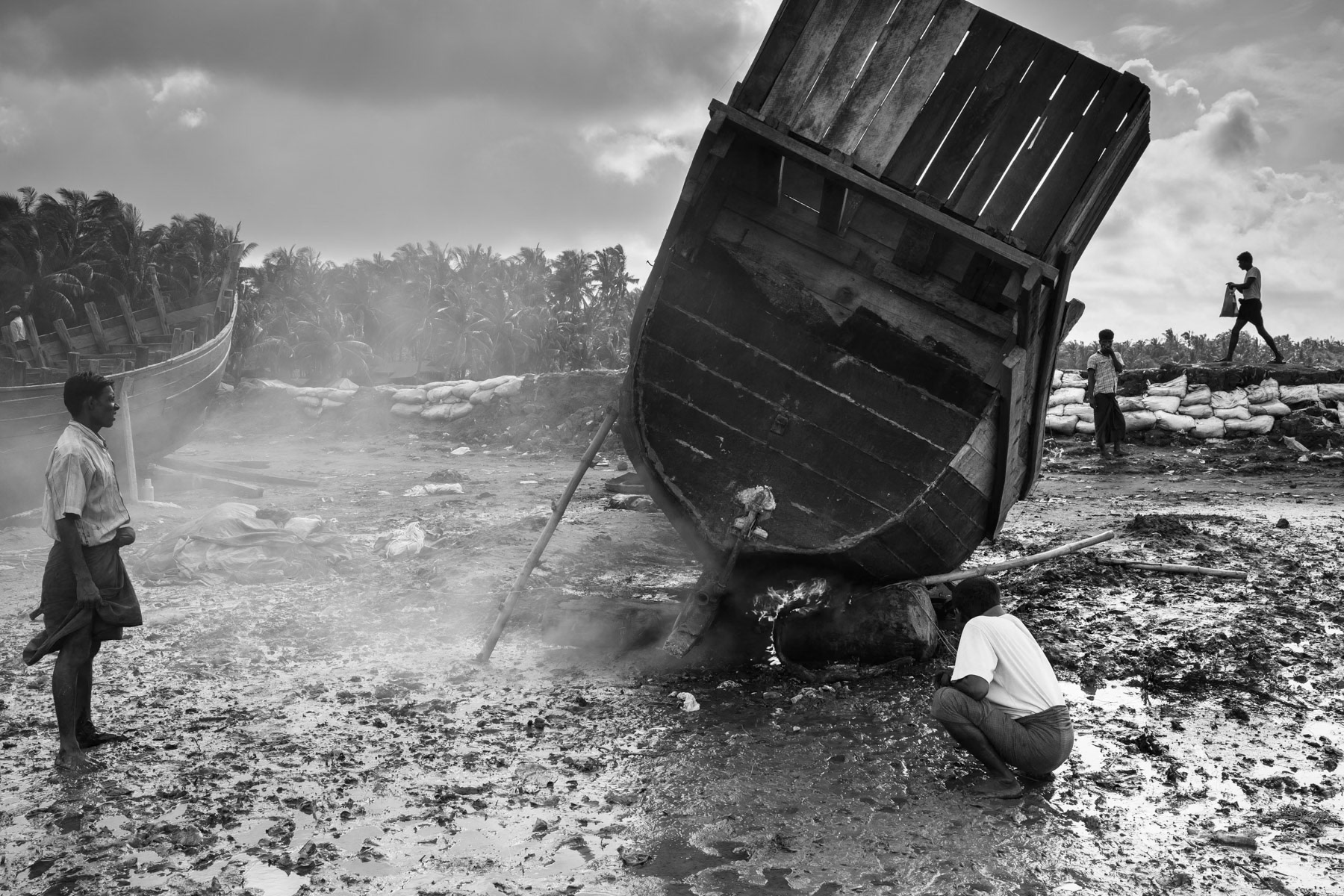 Rohingya fishermen repairing a boat, Thau Chaung village near Sittwe, Myanmar, September 2015