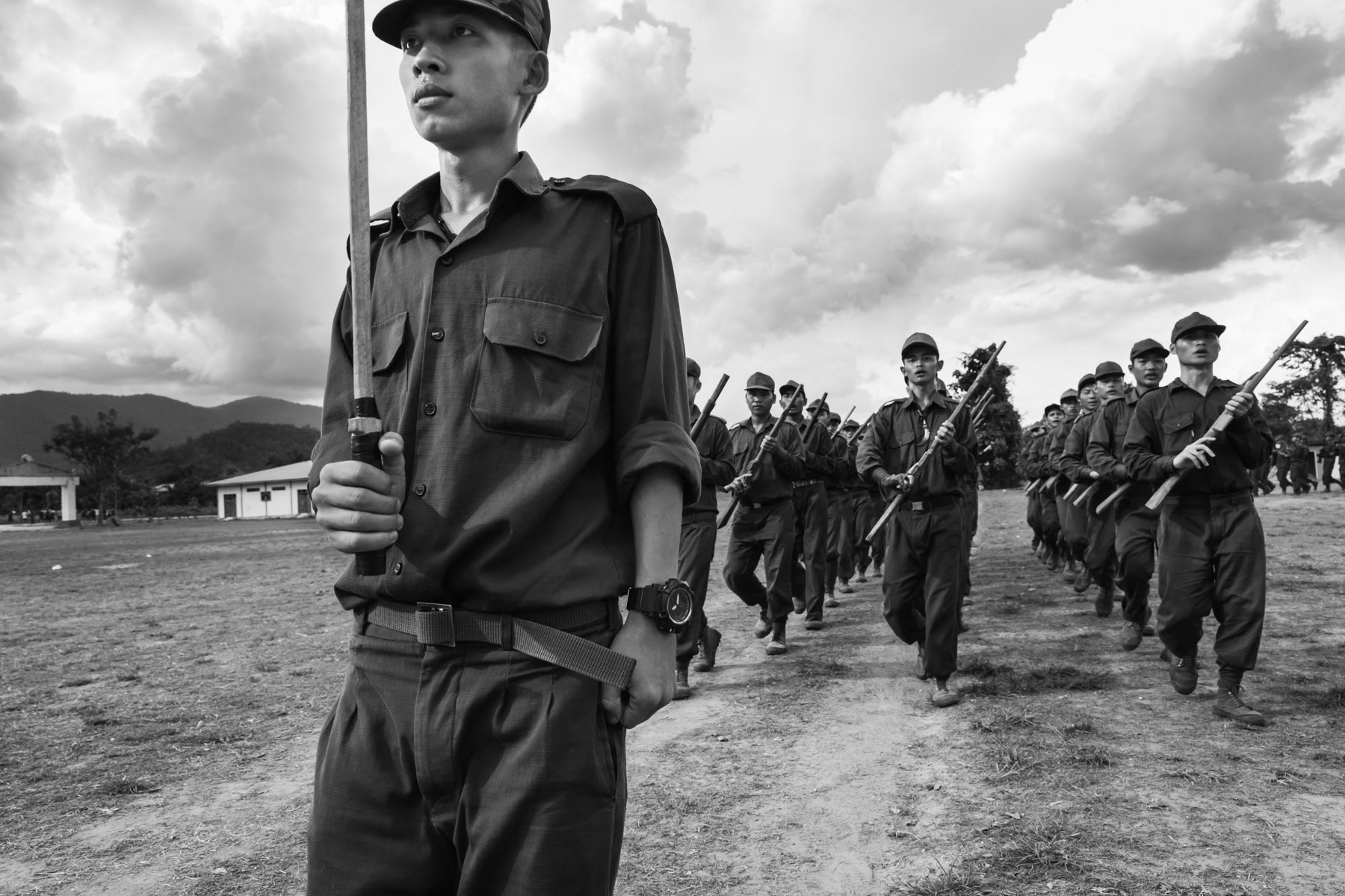 The Karen are an ethnic minority of Myanmar and live mainly in the Eastern region of Kayin along the Thai border. The Karen minority makes up approximately 7% of the Burmese population. The Karen movement led mainly by the Karen National Union have waged one of the longest war, since 1949, against the central Burmese government seeking first independence but since the seventies a federal system where the autonomy and rights of ethnic minorities would be respected. During this long conflict numerous Karen sought refuge in Thailand where still over a 100,000 refugees live in refugee camps along the border and in the cities. Karen insurgent groups control large swatches of territory in Eastern Kayin State along the Thai border and try very hard to organise their territory by providing health and education while keeping military forces ready to defend their terrotory and freedom. Democratic Karen Buddist Army recruits following a 3 months long training at a military training center in Karen State. Myanmar, November 2018