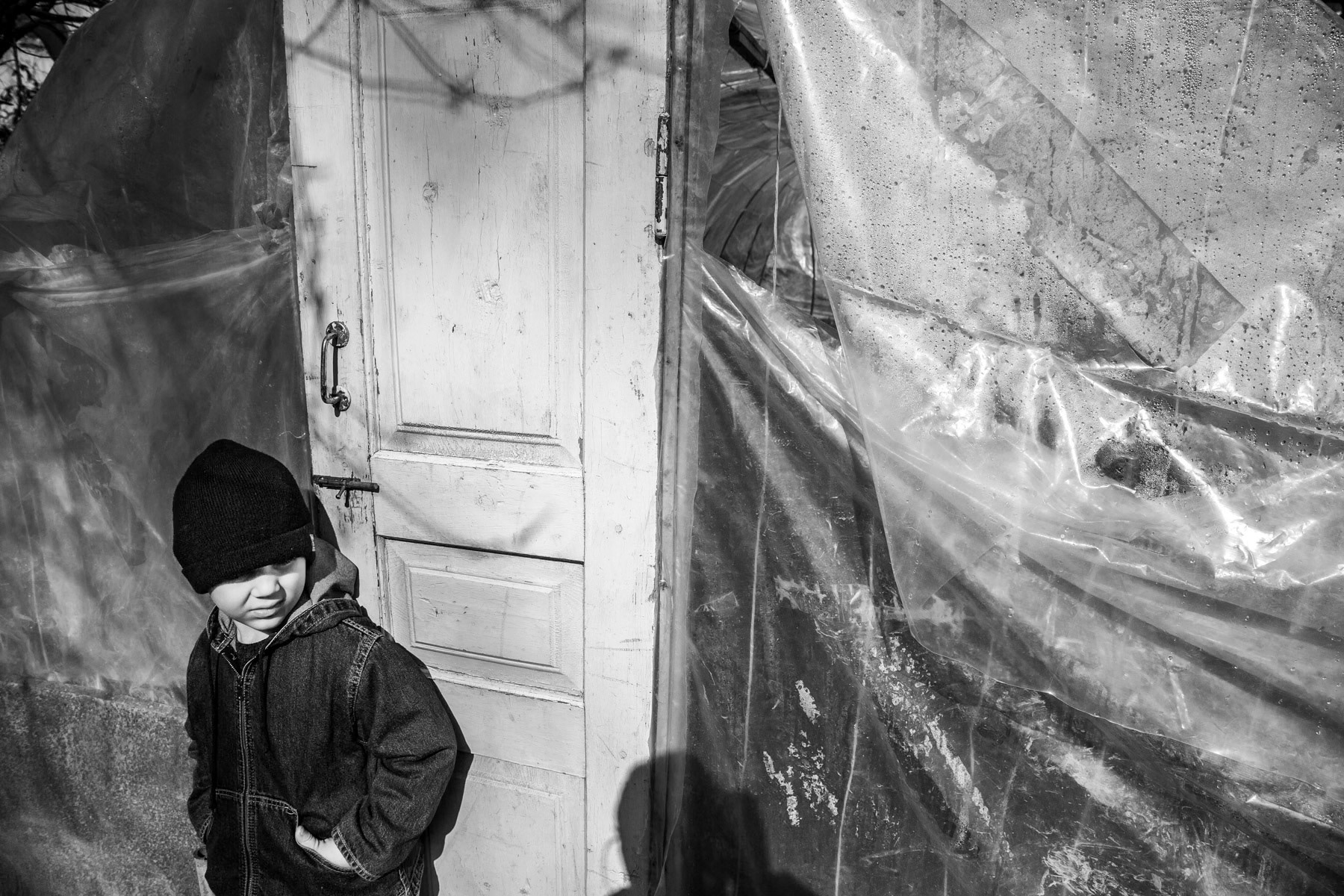 Child in front of his father's greenhouse. Shushi, March 2014