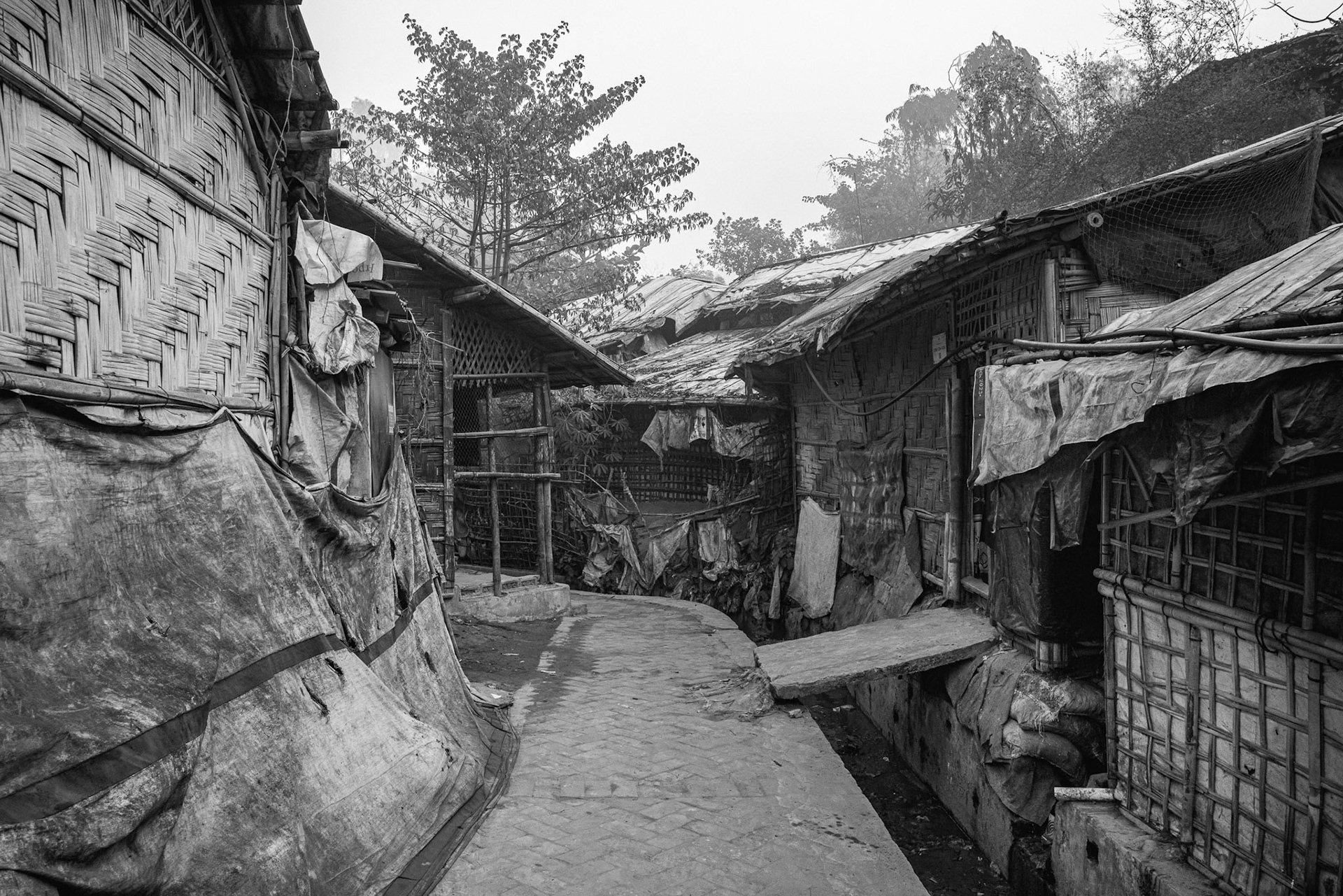 Without the right to build permanent structures, refugees must constantly repair their bamboo huts to survive the heavy tropical rains and cyclones. Balukhali camp, Bangladesh, January 2026