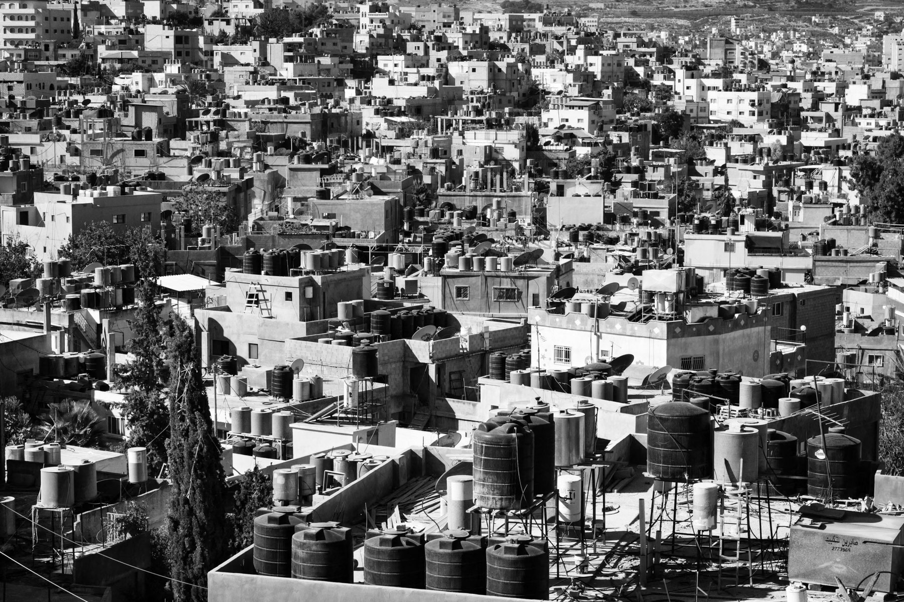 With very sporadic water supply, roofs are being covered with tanks to build up reserves, Dheisheh refugee camp in Bethlehem, Palestine, November 2013