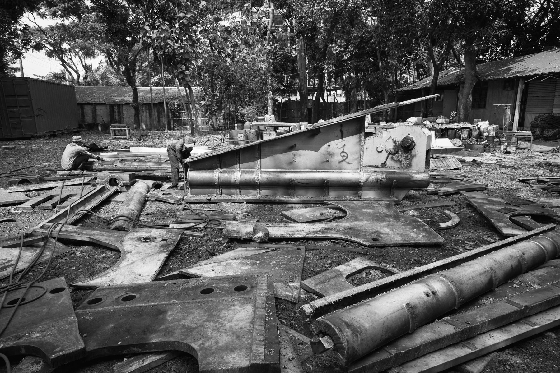 Large boat parts being reduced to transporatble pieces before being sold to the steel recycle plant. Bhatiary ship breaking yards, Bangladesh, October 2014