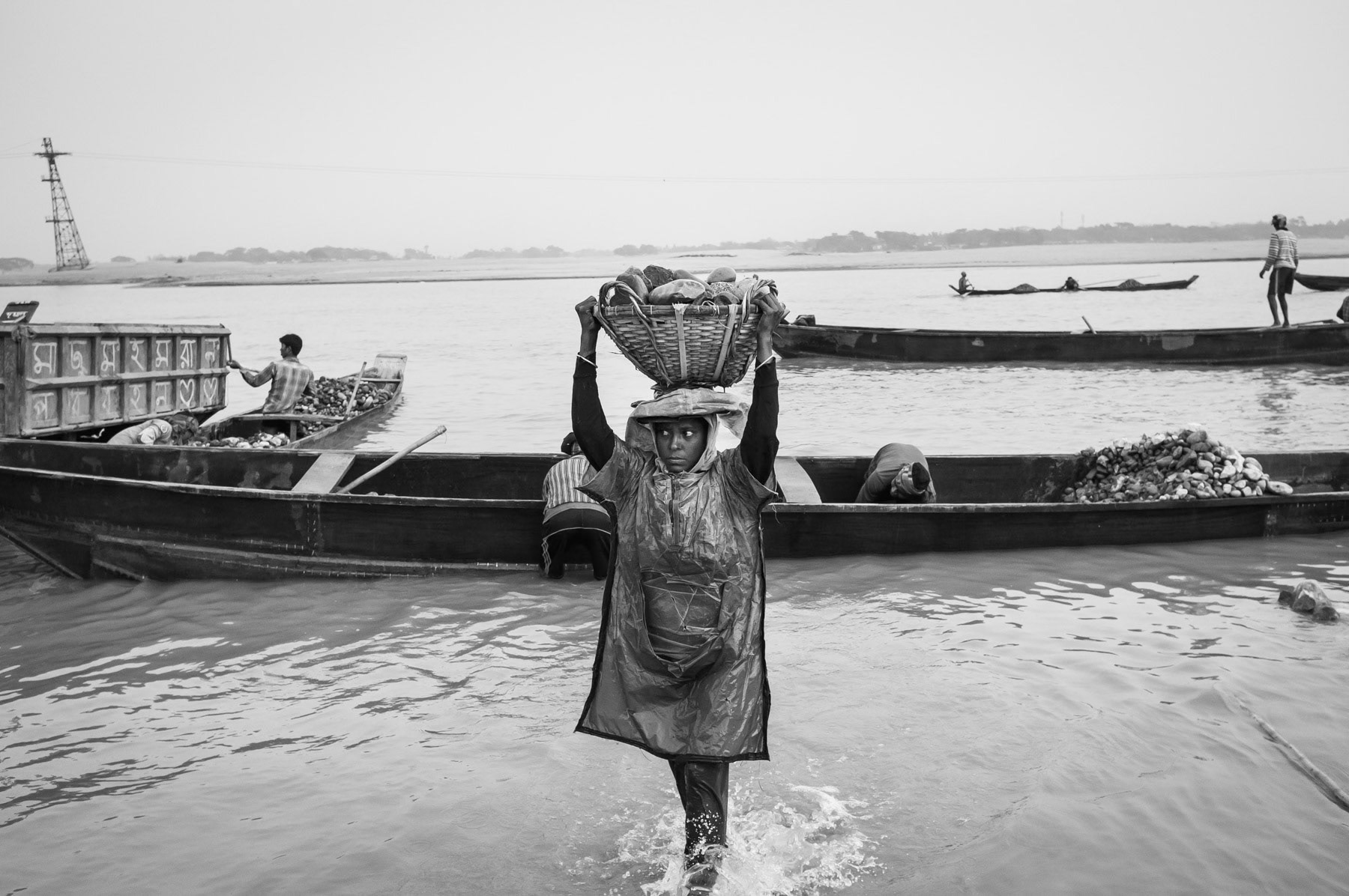 Woman unloading a small barge, Bholaganj, Bangladesh, December 2015