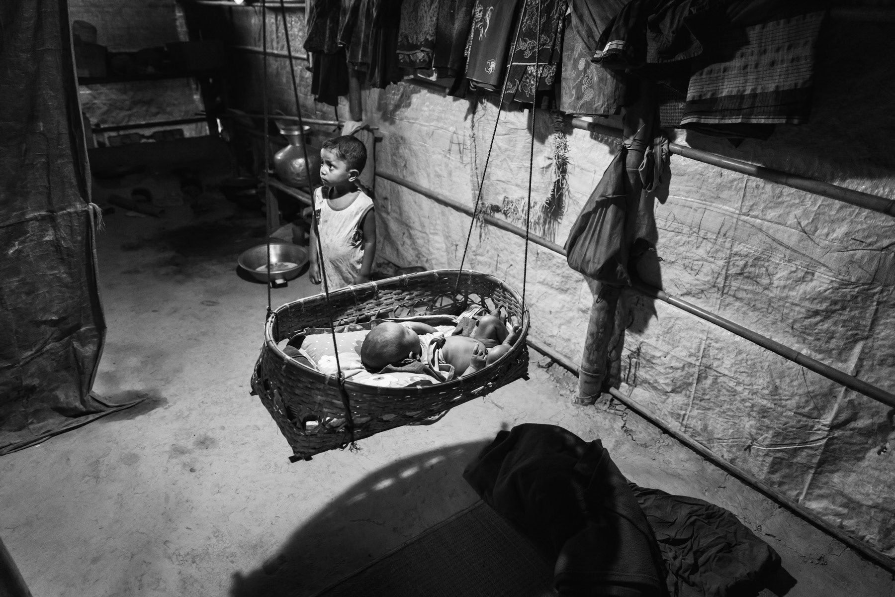 Moria Khatun's first son and her new born son from Maungdaw township in Myanmar. His mother was tortured, blindfolded, tightened and gang raped for 4 hours by military and local Rakhine. After the military left the village, her husband who was hiding in the jungle, came to evacuate them. Nuru Hafez the little baby boy was born in June 2018 nine months after his mother had been raped. Balukhali refugee camp in Bangladesh, October 2018