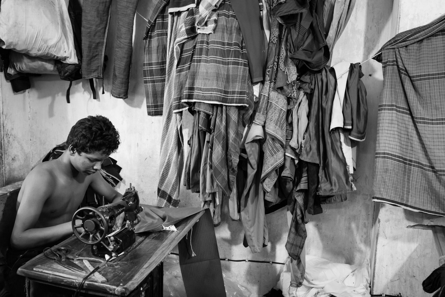 Workers are paid half a dollar per pant they produce, the same pant will be sold in the nearby local garment market for five dollar. Dhaka, May 2015