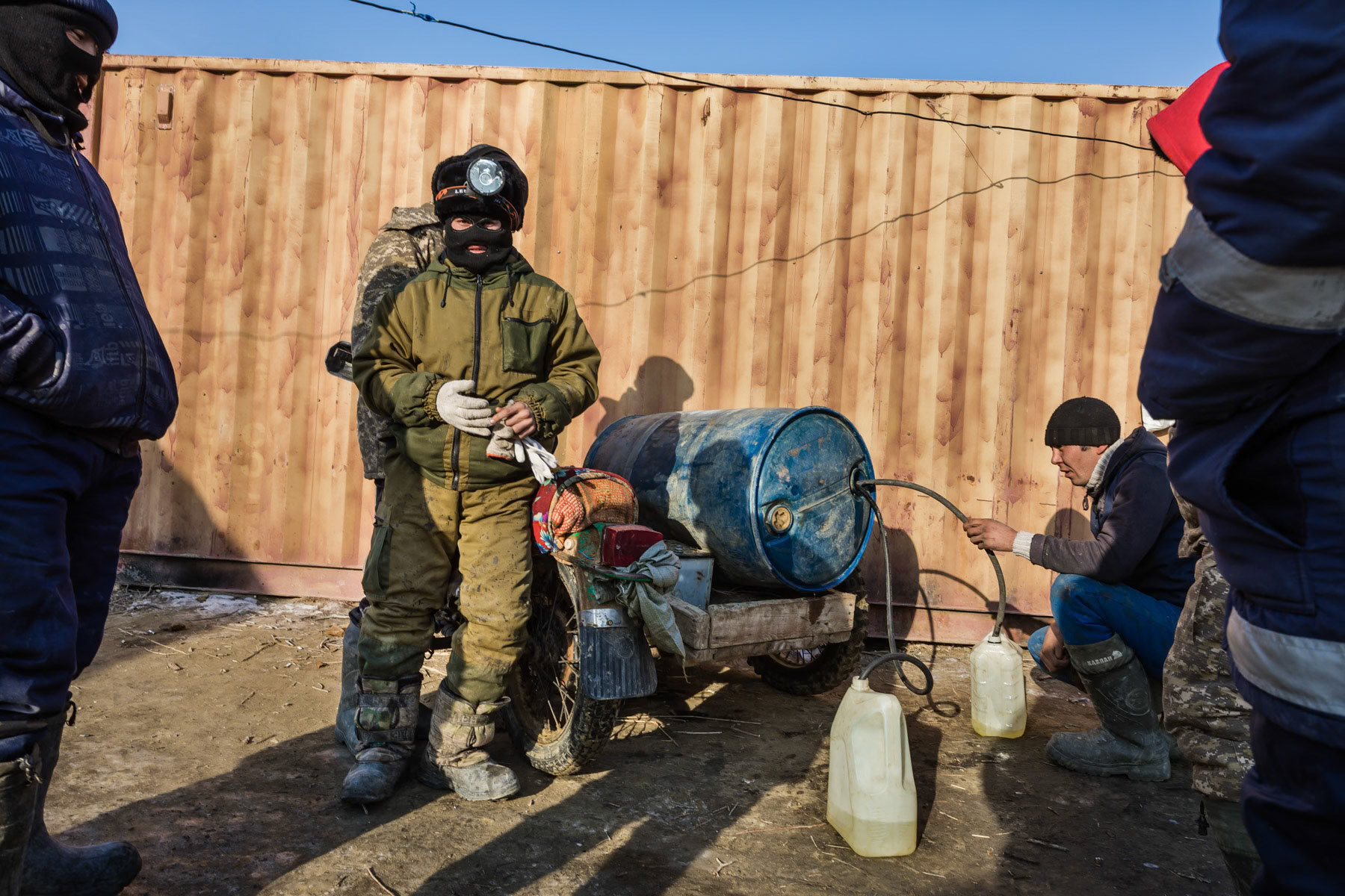 Petrol distribution before heading with trucks on the frozen Aral Sea. Base camp of the ice fishermen, Kazakhstan, January 2019