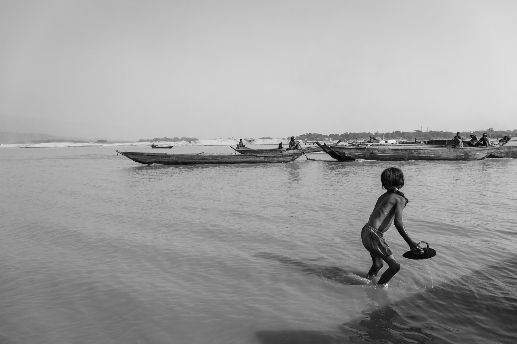 Dholai river in Bholaganj where stone extracted from the river are brought at land, Sylhet region, Bangladesh, December 2015