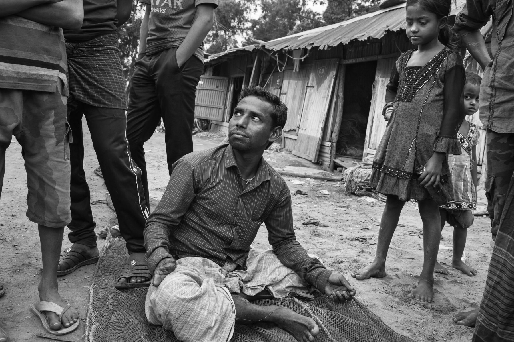 Work accident victim while working on the ship breaking yards. Repairing fishing nets to survive. Kumira, Bangladesh, October 2014