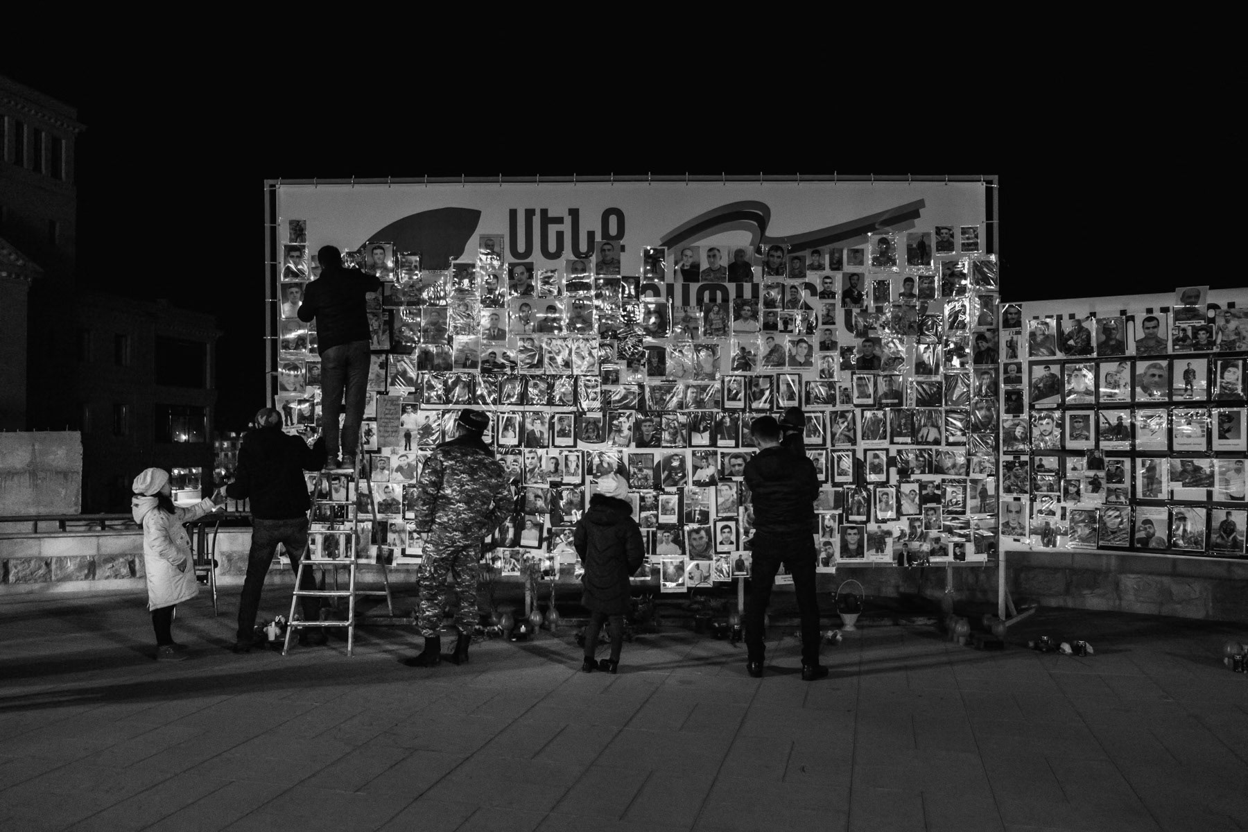 Residents adding pictures of soldiers killed or gone missing during the past 44-day war that saw more than 6000 people killed on both sides. Republic Square, Stepanakert, Nagorno-Karabakh, January 2021