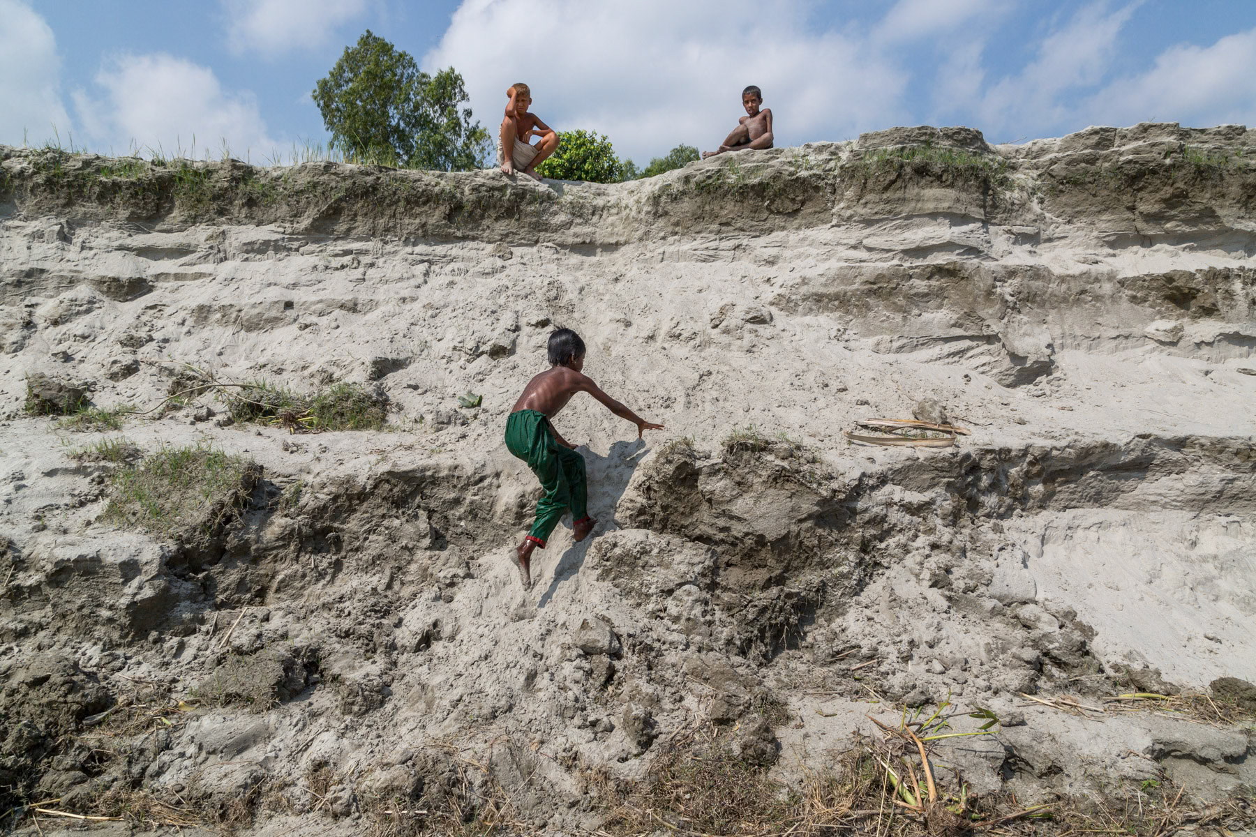 Playing on the edge of the river island. Most of the river islands, or chars, are flooded for several months per year. Bhati char, Bangladesh, October 2014