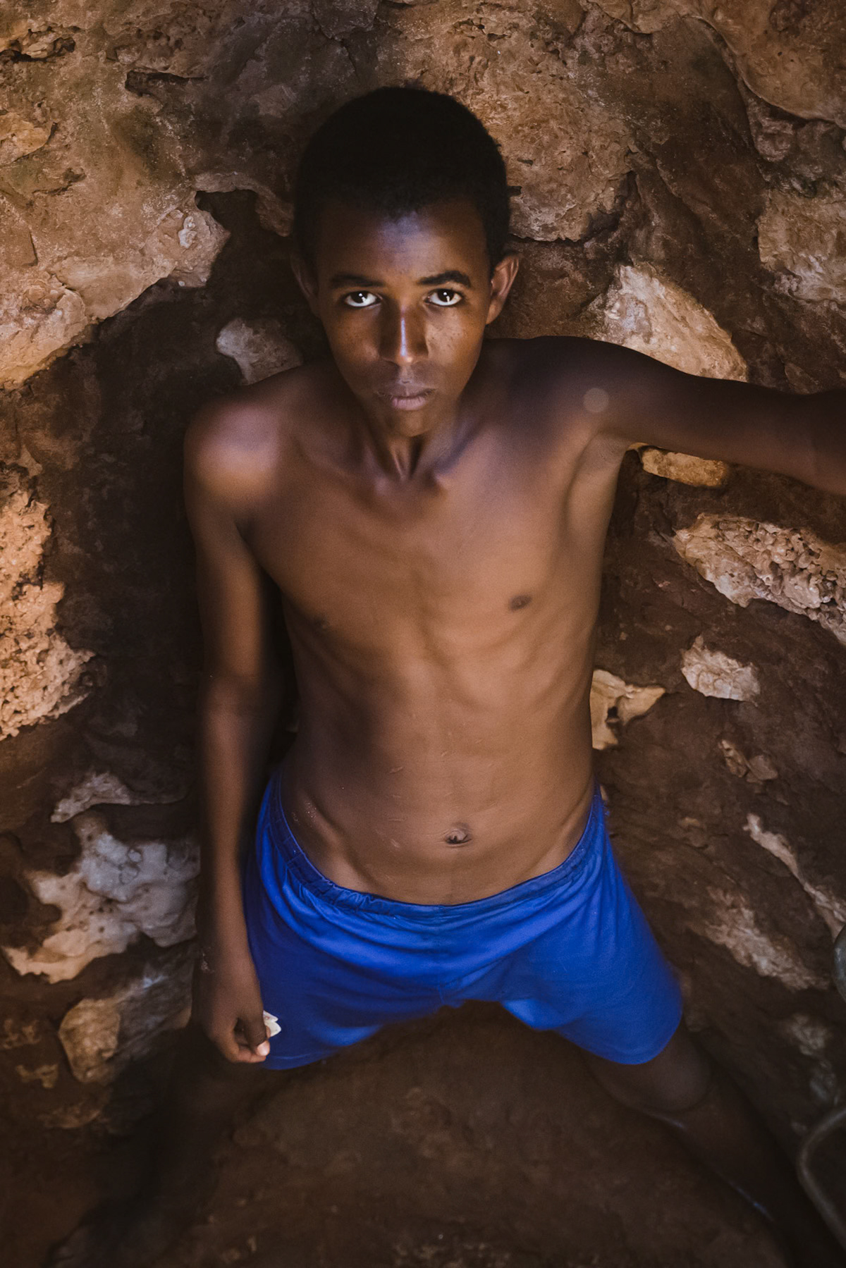 Deep inside the well retrieving the last drops of water. The eastern regions of Somaliland have been affected by 4 years of severe droughts, disseminating up to 80% of the region's livestock. Togdheer district, Somaliland, October 2017