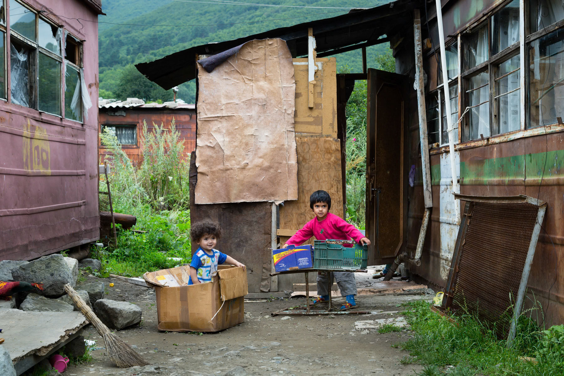 Children playing in their yard, domik settlement in Vanadzor, Armenia, July 2014